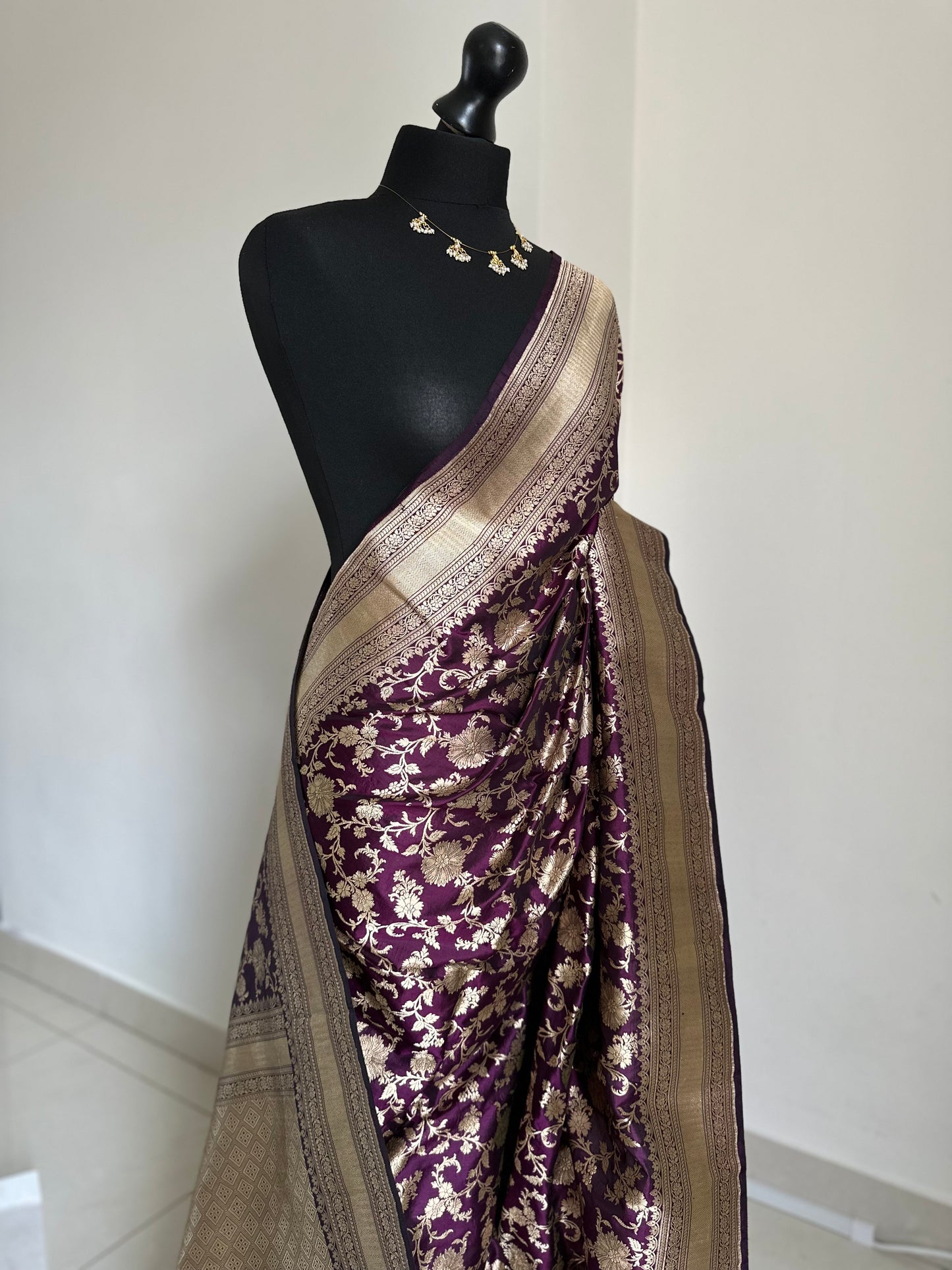 Elegant deep wine pure silk Banarasi saree with intricate gold zari work and floral motifs, perfect for weddings and festive occasions