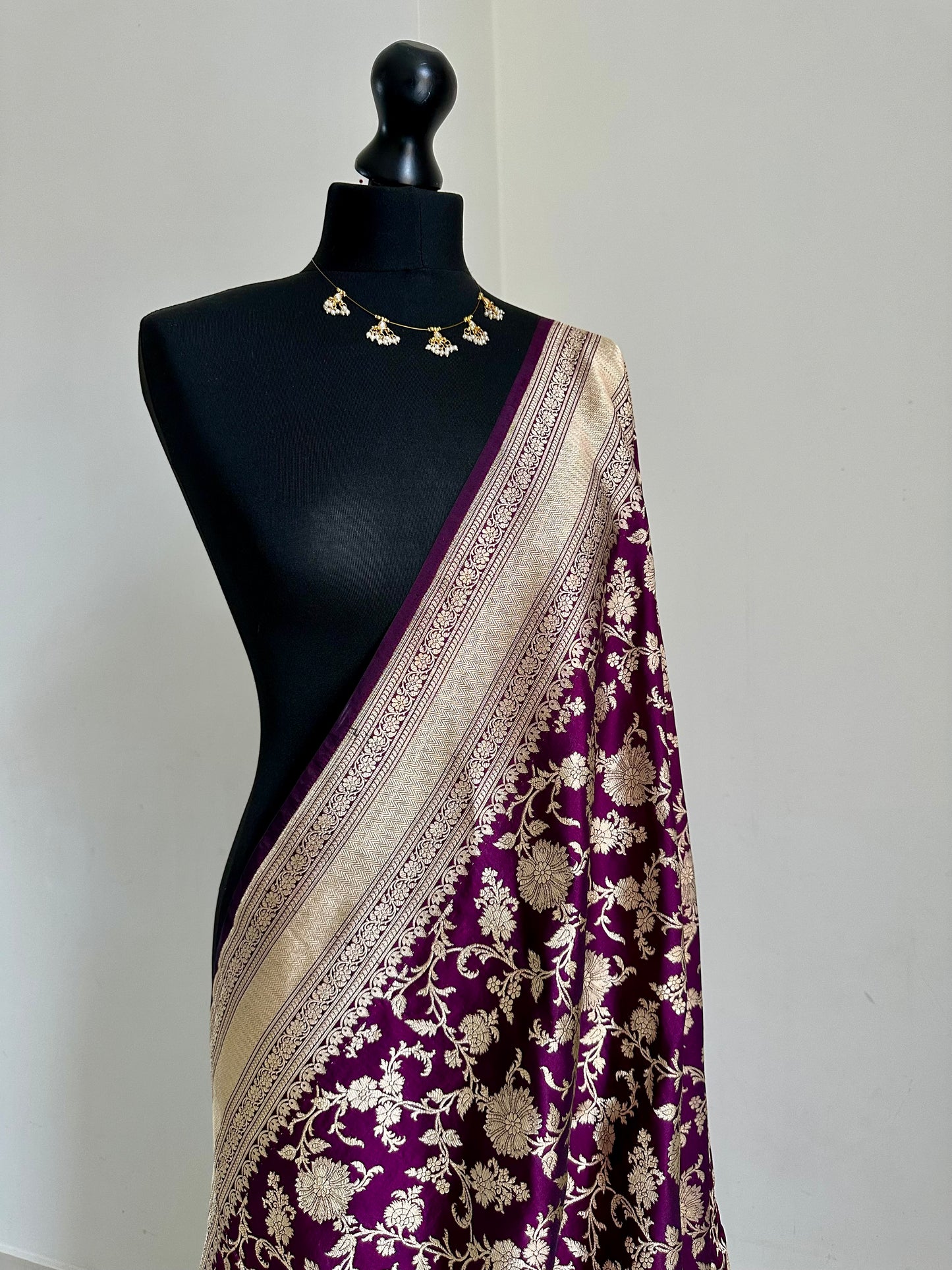 Elegant deep wine pure silk Banarasi saree with intricate gold zari work and floral motifs, perfect for weddings and festive occasions