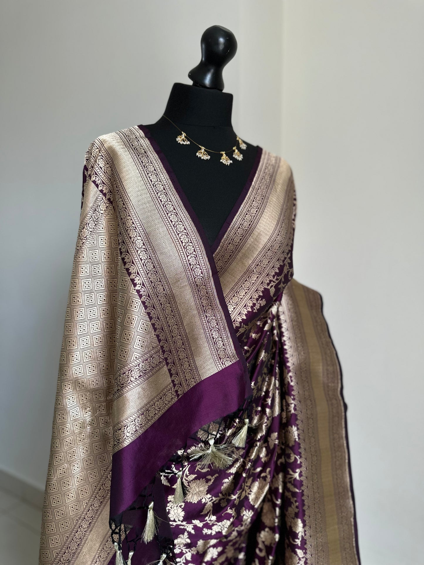 Elegant deep wine pure silk Banarasi saree with intricate gold zari work and floral motifs, perfect for weddings and festive occasions