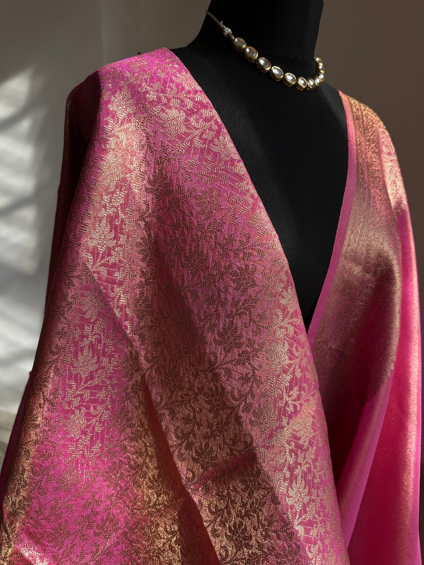 Pink and antique gold semi tissue silk saree. Unstitched brocade blouse.