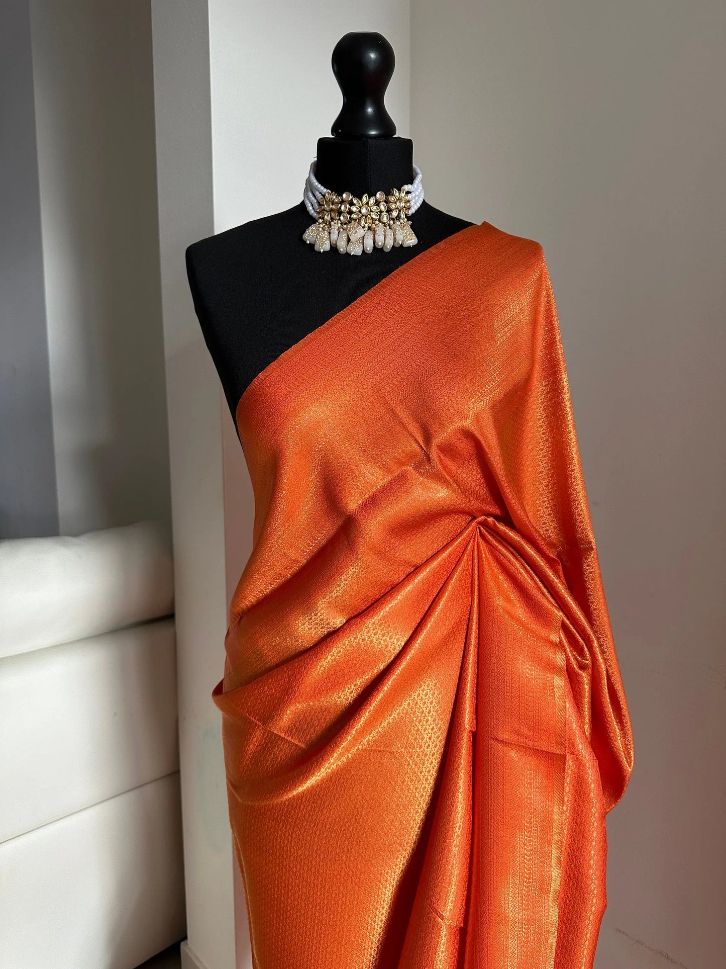 Orange soft silk saree with a copper border and all over sheen. The perfect saree for parties and all traditional events. Versatile saree - LaiLai Sarees
