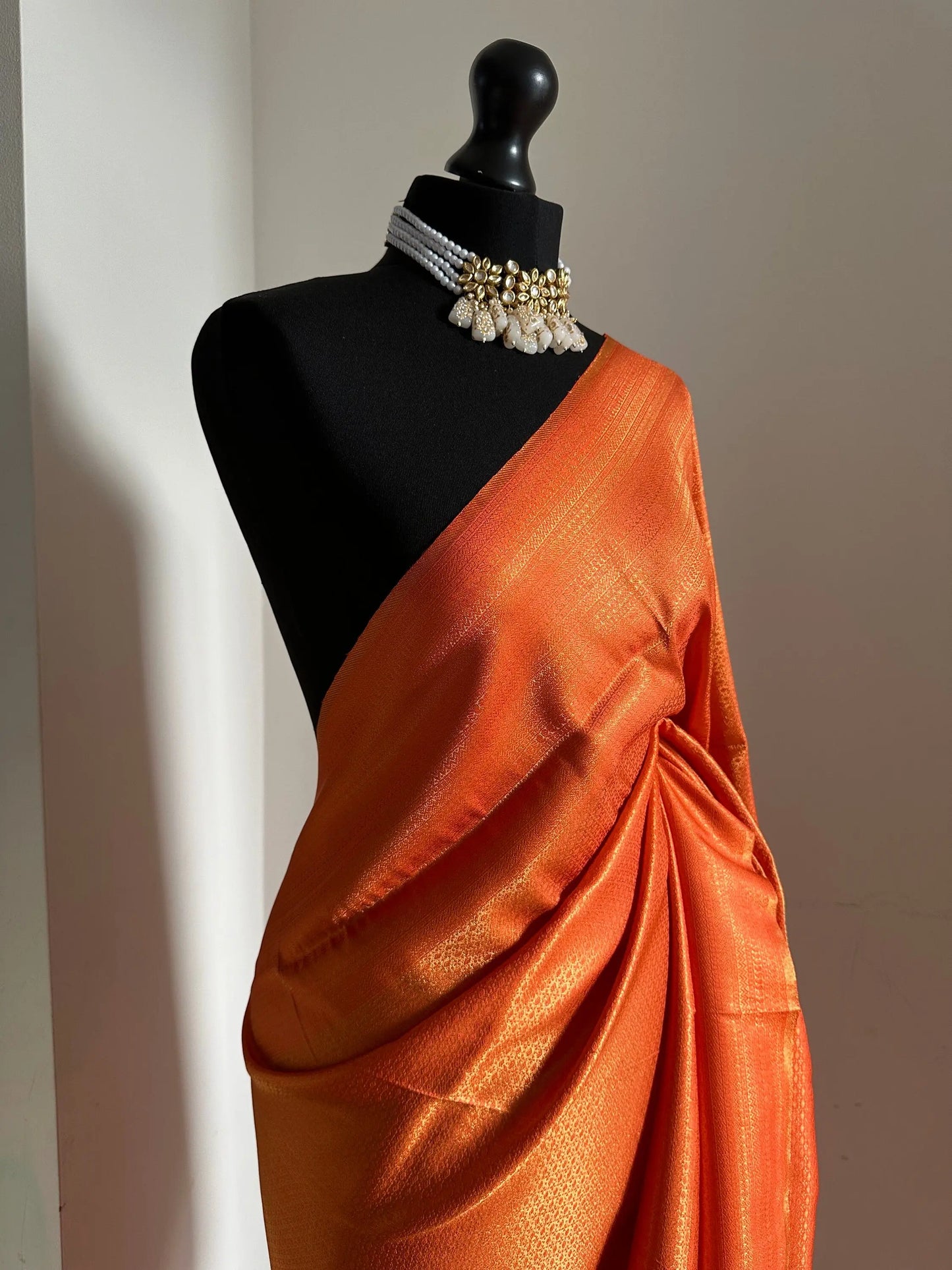 Orange soft silk saree with a copper border and all over sheen. The perfect saree for parties and all traditional events. Versatile saree - LaiLai Sarees