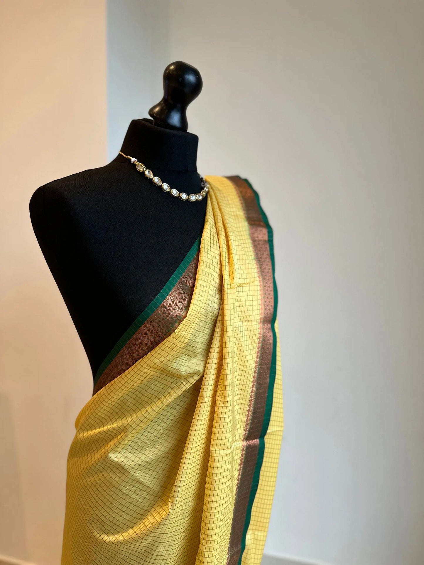 Yellow and green crepe binny silk saree with contrast border, pallu and blouse. Beautiful checks gives a stylish twist to this saree - LaiLai Sarees