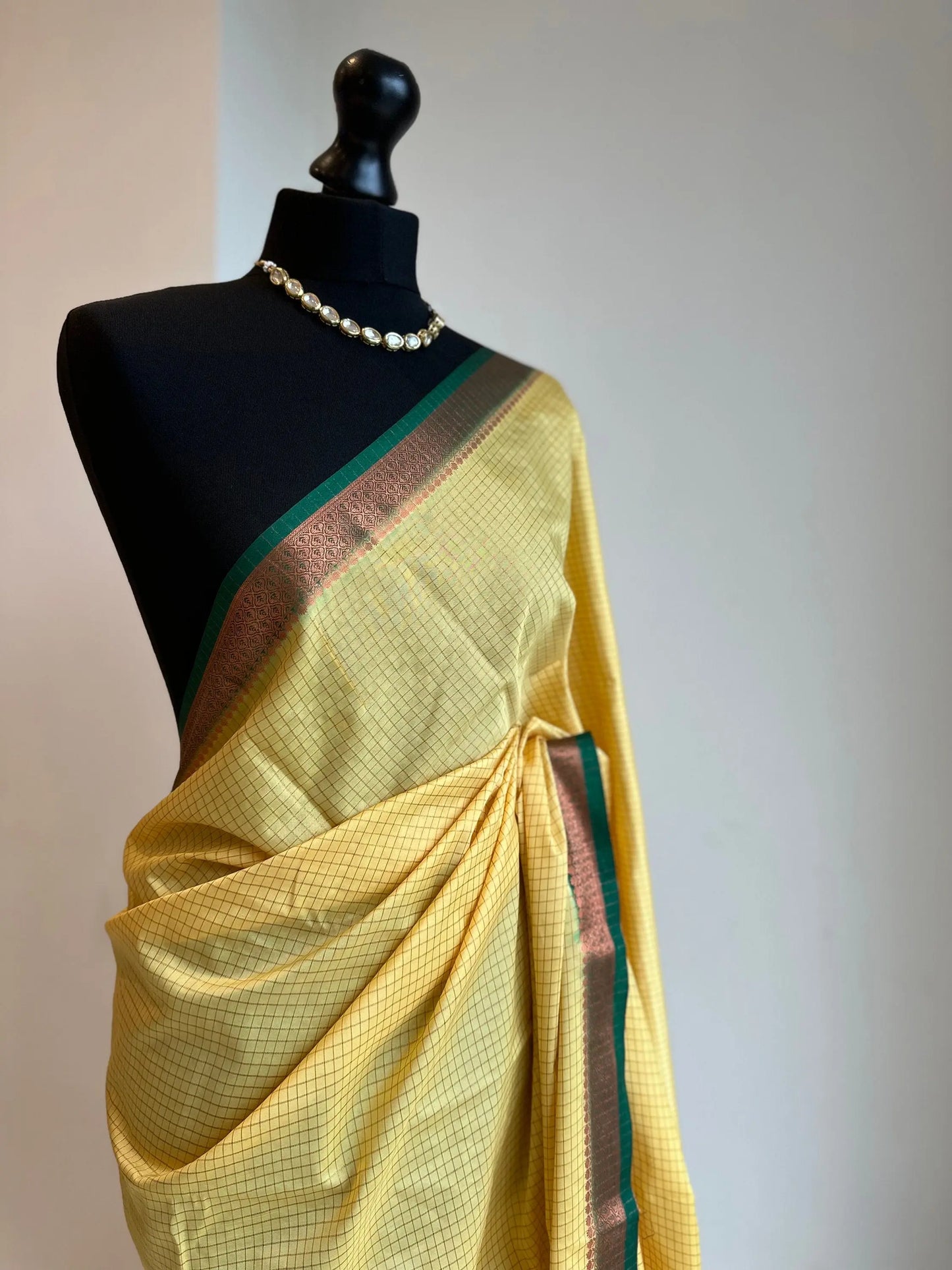 Yellow and green crepe binny silk saree with contrast border, pallu and blouse. Beautiful checks gives a stylish twist to this saree - LaiLai Sarees