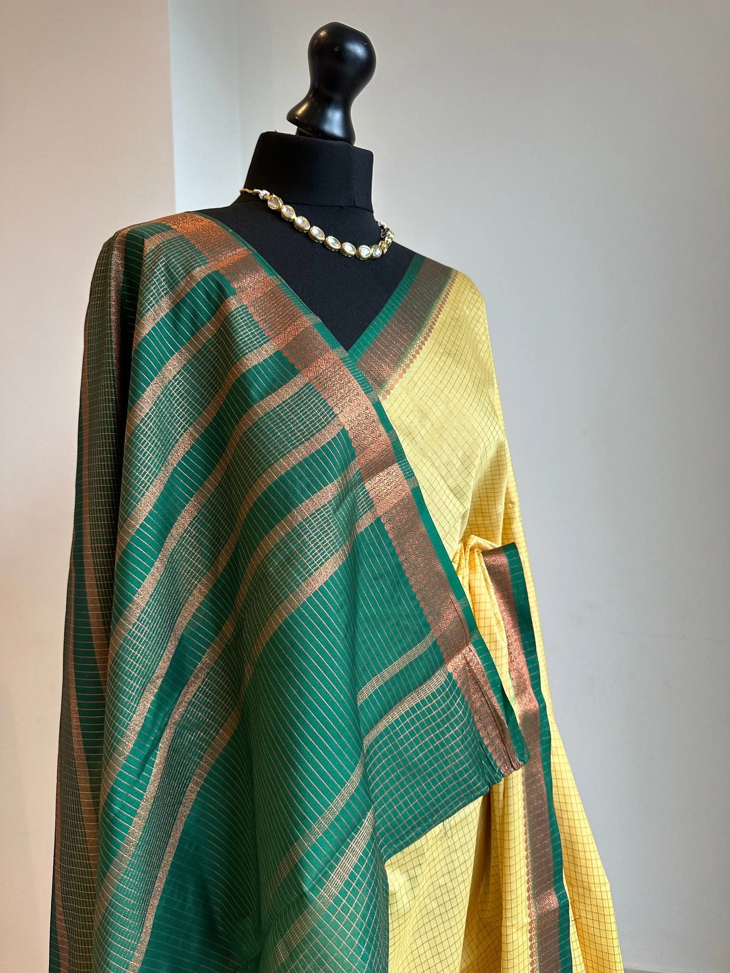 Yellow and green crepe binny silk saree with contrast border, pallu and blouse. Beautiful checks gives a stylish twist to this saree - LaiLai Sarees