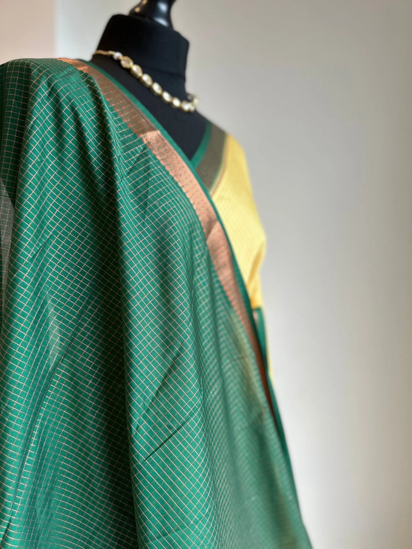 Yellow and green crepe binny silk saree with contrast border, pallu and blouse. Beautiful checks gives a stylish twist to this saree - LaiLai Sarees