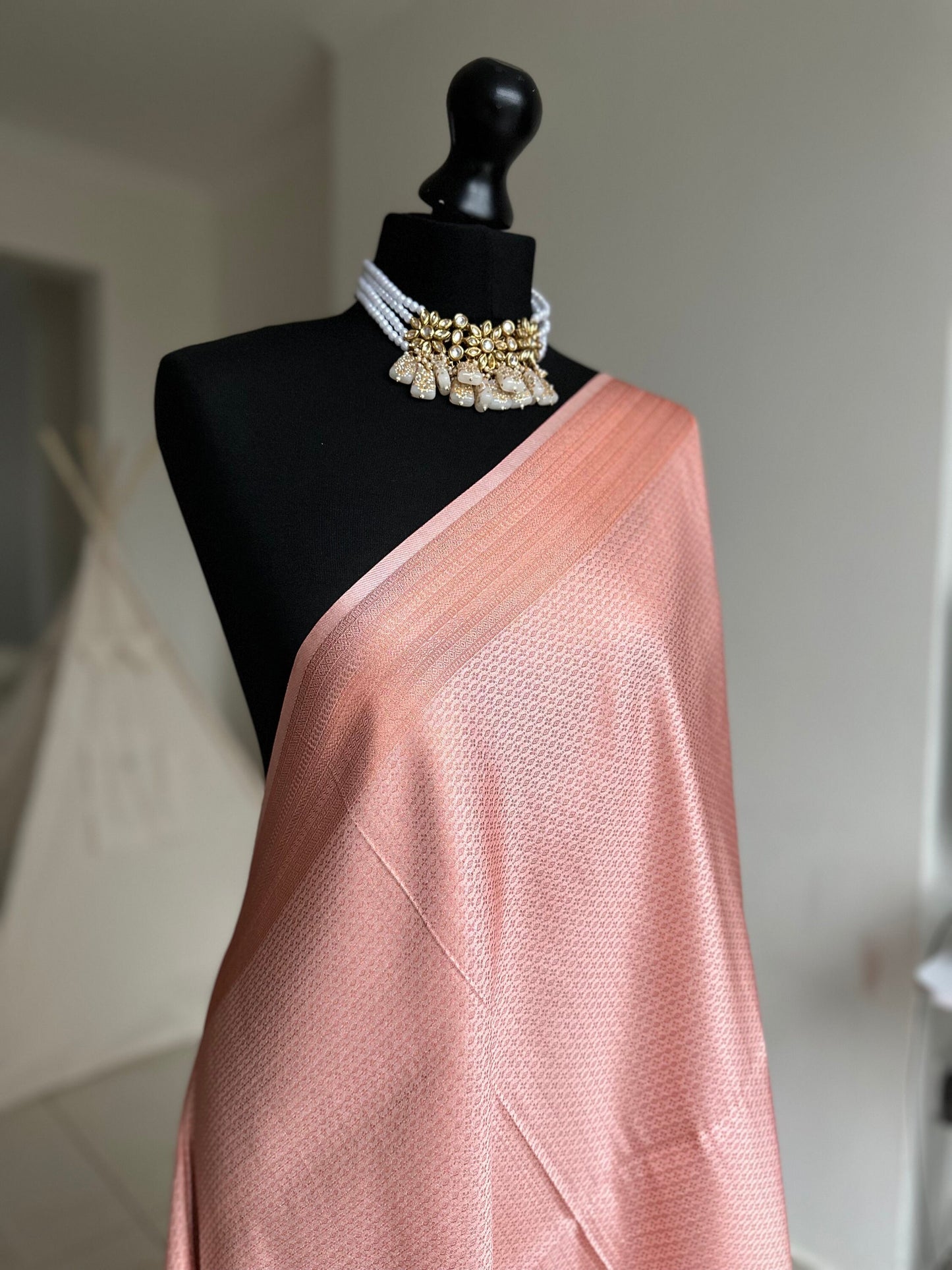 Pink soft silk saree with a copper border and all over sheen. The perfect saree for parties and all traditional events. Versatile saree