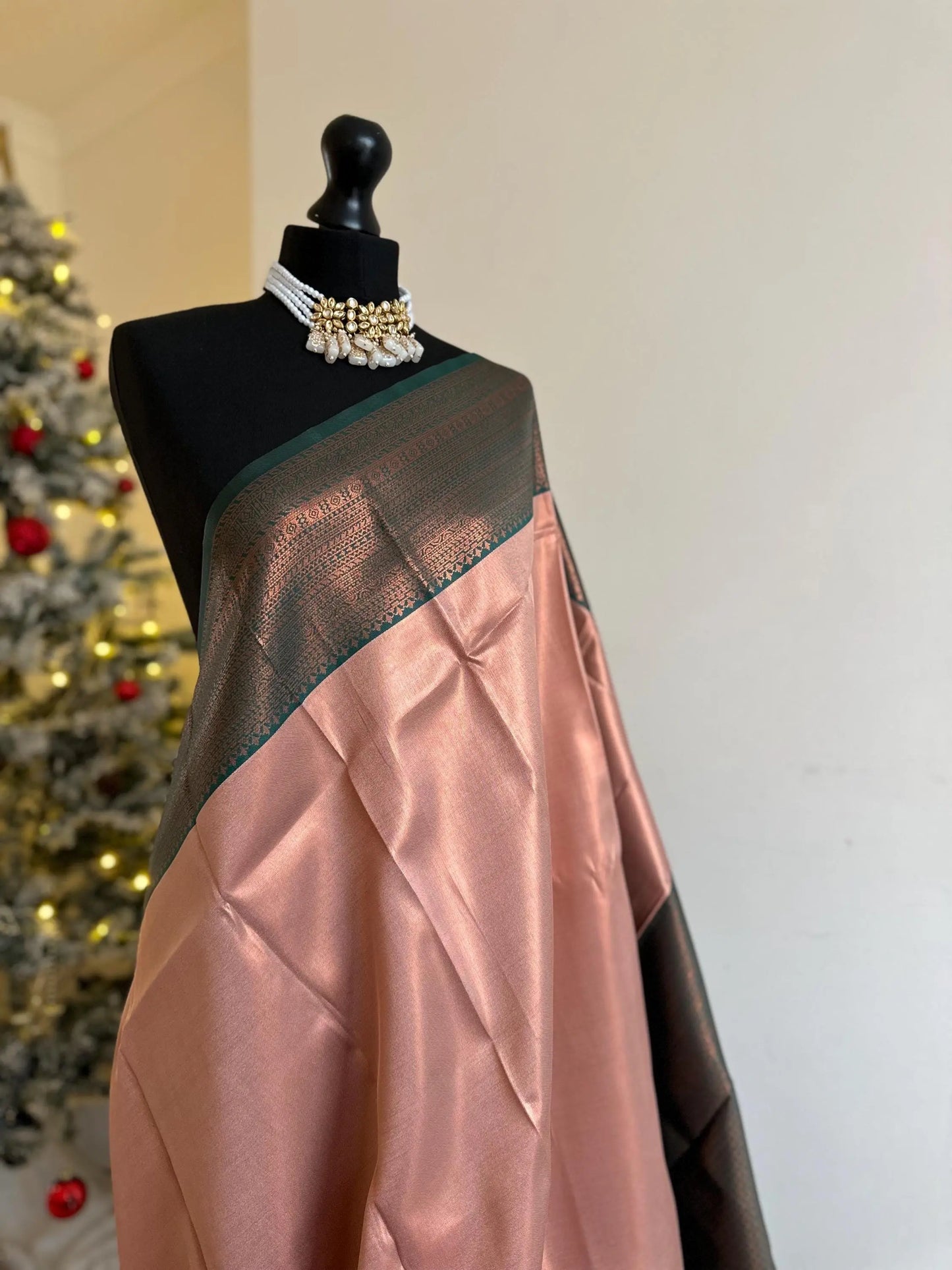 Semi silk peach pink saree with green border and copper motifs. Modern and traditional silk saree beautiful colour and design.Designer saree - LaiLai Sarees