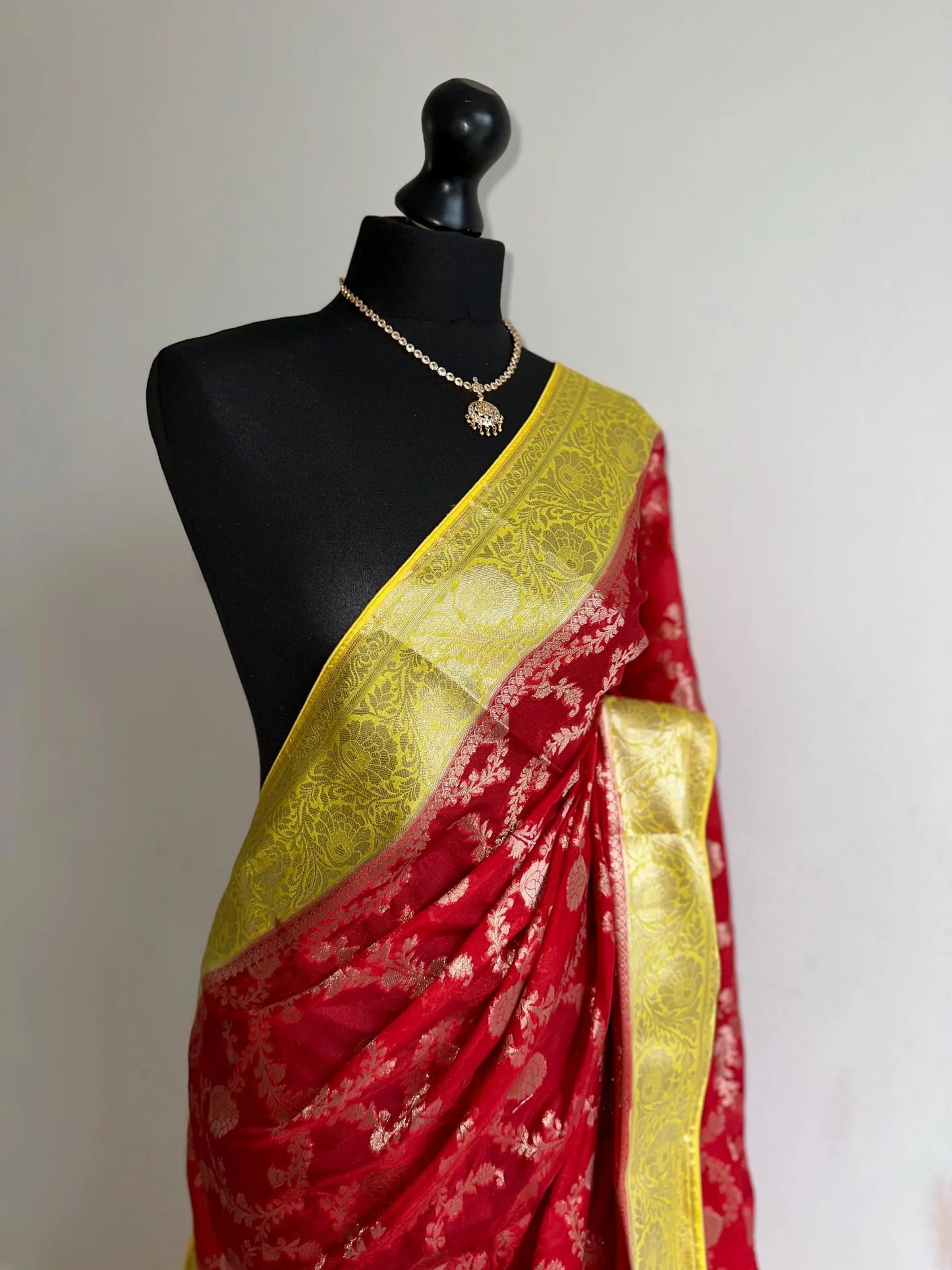 Semi Banarasi georgette silk saree in red with yellow border. Adorned with gold jaal & Zari. Wedding party event saree in unique colours - LaiLai Sarees