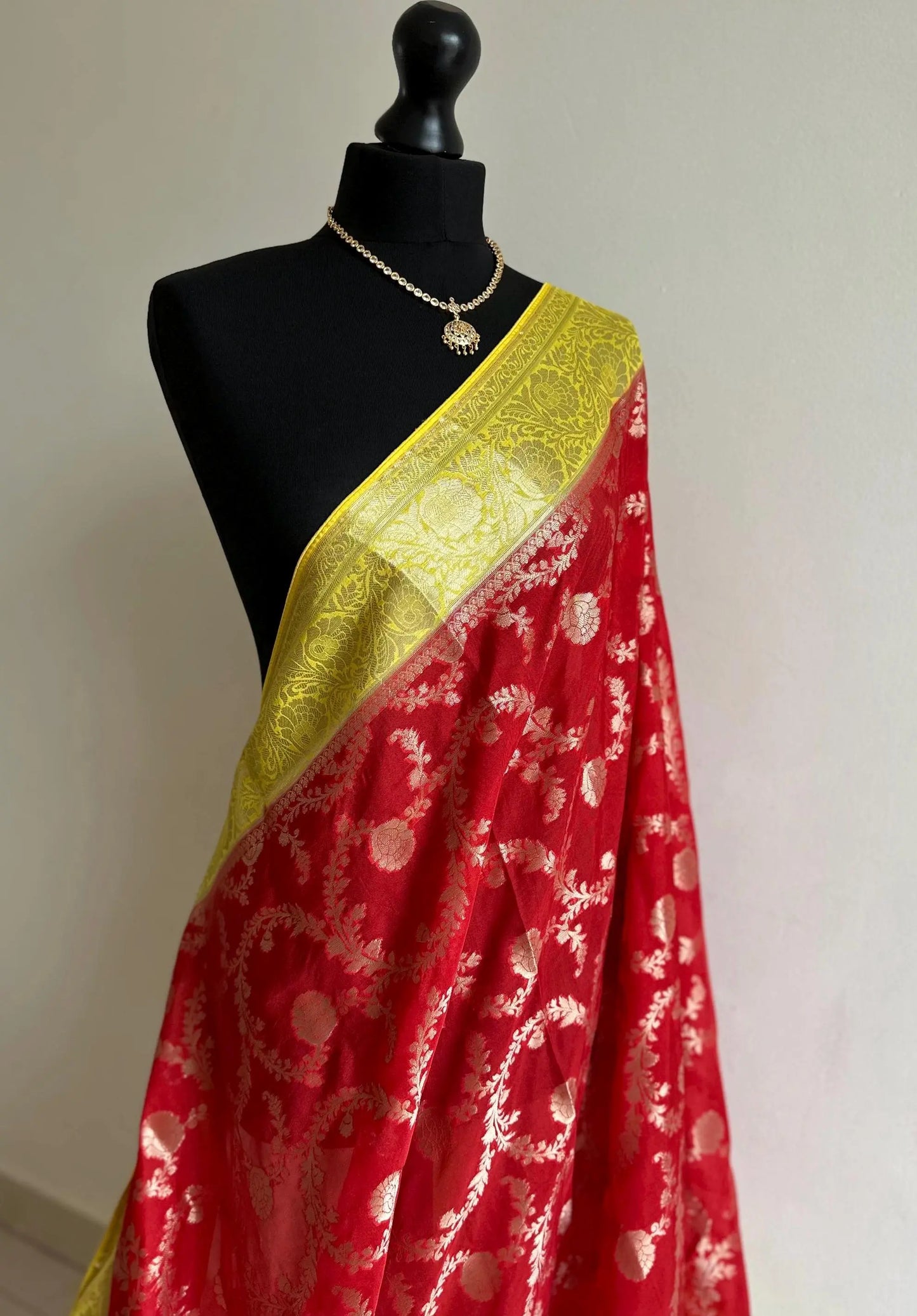 Semi Banarasi georgette silk saree in red with yellow border. Adorned with gold jaal & Zari. Wedding party event saree in unique colours - LaiLai Sarees