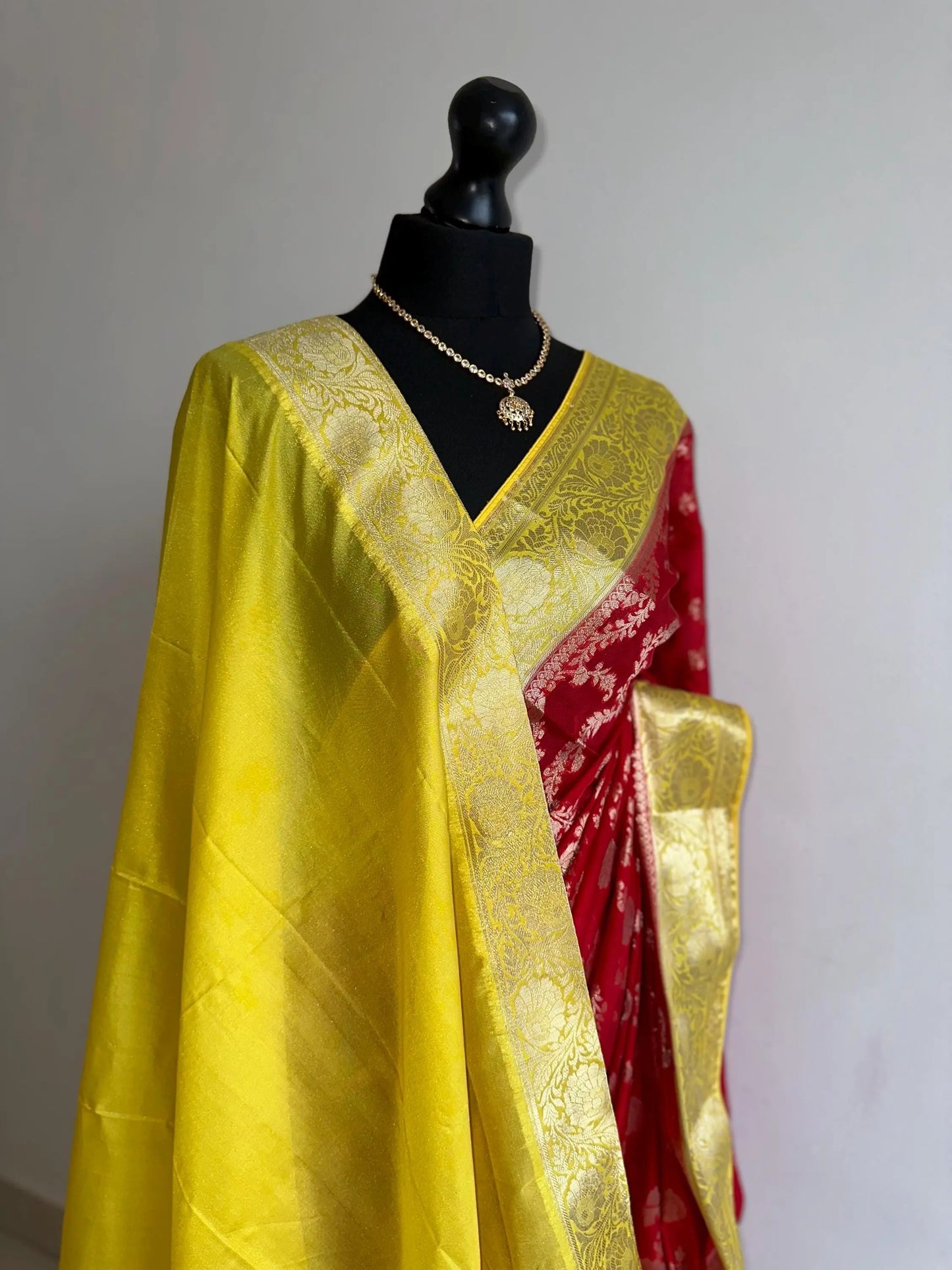 Semi Banarasi georgette silk saree in red with yellow border. Adorned with gold jaal & Zari. Wedding party event saree in unique colours - LaiLai Sarees
