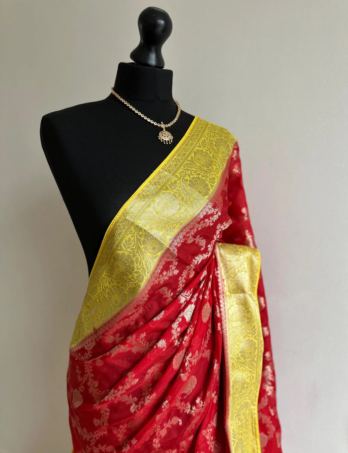 Semi Banarasi georgette silk saree in red with yellow border. Adorned with gold jaal & Zari. Wedding party event saree in unique colours - LaiLai Sarees