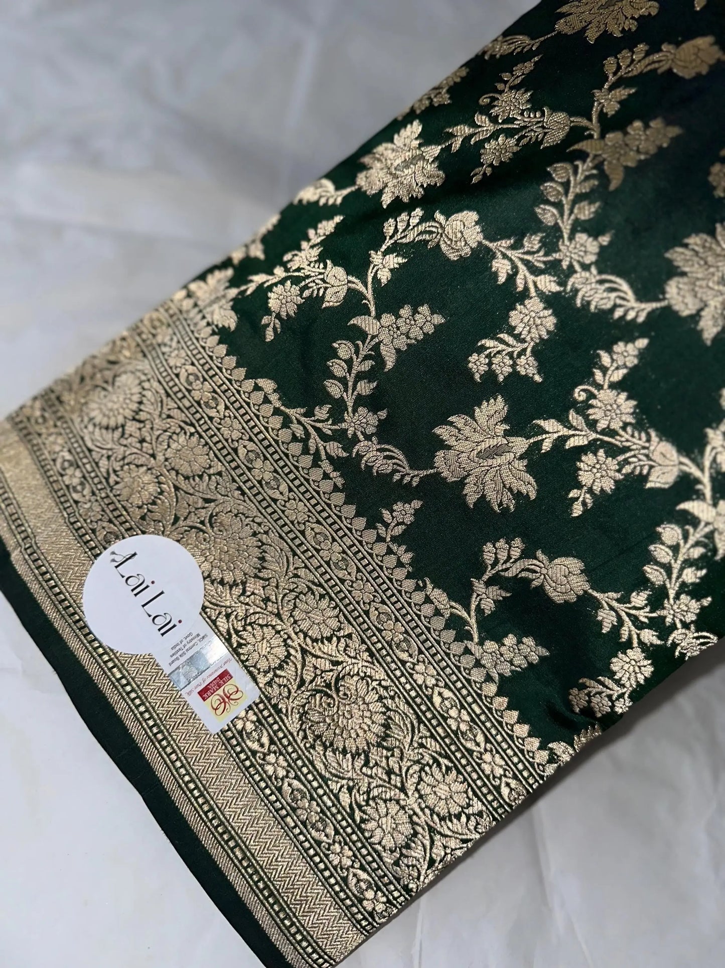 Elegant dark green pure silk Banarasi saree with intricate gold zari work and floral motifs, perfect for weddings and festive occasions Etsy