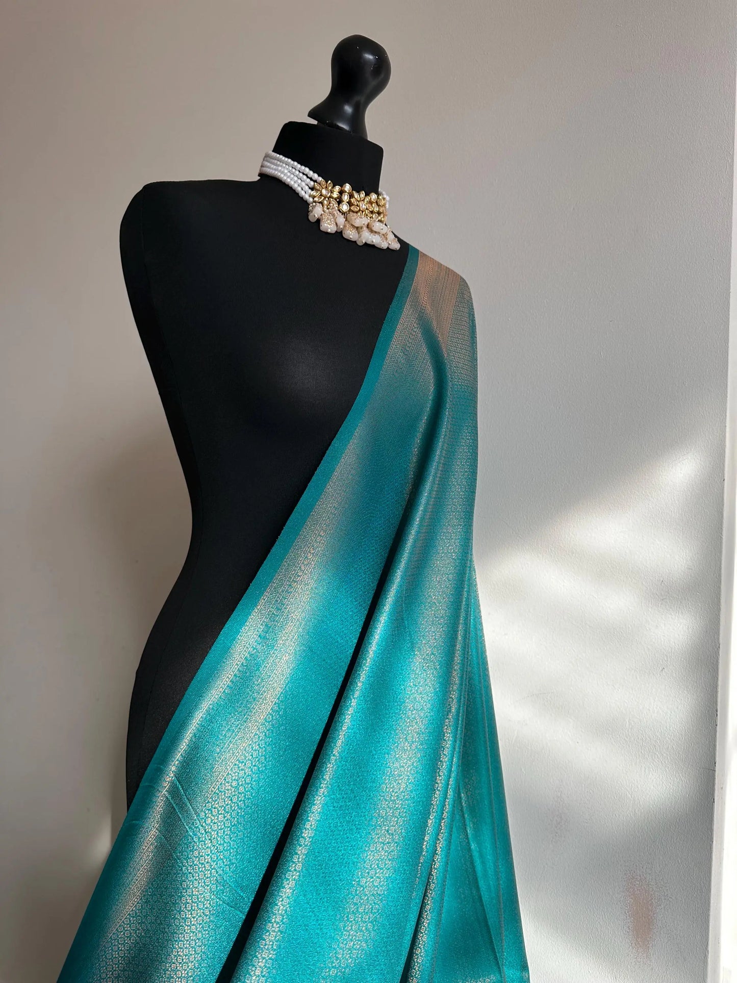 Sea green soft silk saree with a copper border and all over sheen. The perfect saree for parties and all traditional events. - LaiLai Sarees