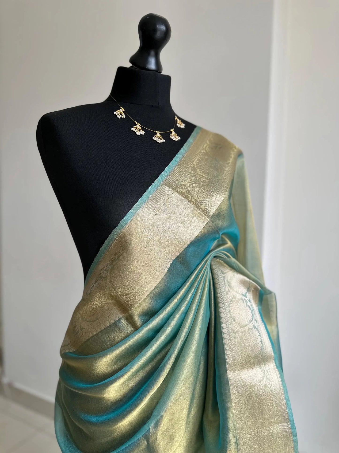 Gold and sea green dual toned plain shimmer soft tissue saree with border and unstitched blouse. Statement tissue saree for wedding events LaiLai Sarees
