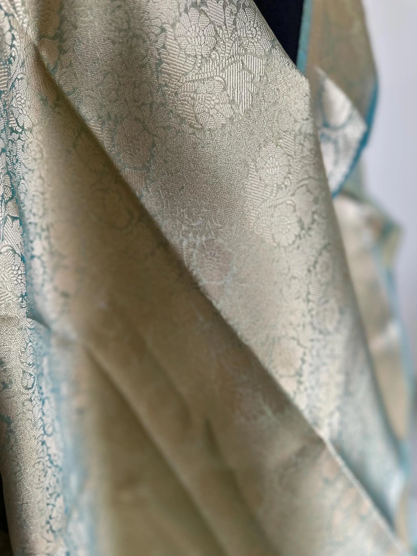 Gold and sea green dual toned plain shimmer soft tissue saree with border and unstitched blouse. Statement tissue saree for wedding events LaiLai Sarees