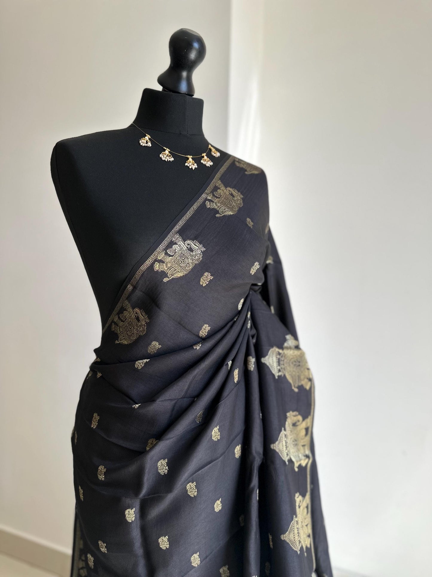 Black semi silk saree with subtle gold zari elephant border and polka dot blouse. Traditional Indian saree elegant festive wear