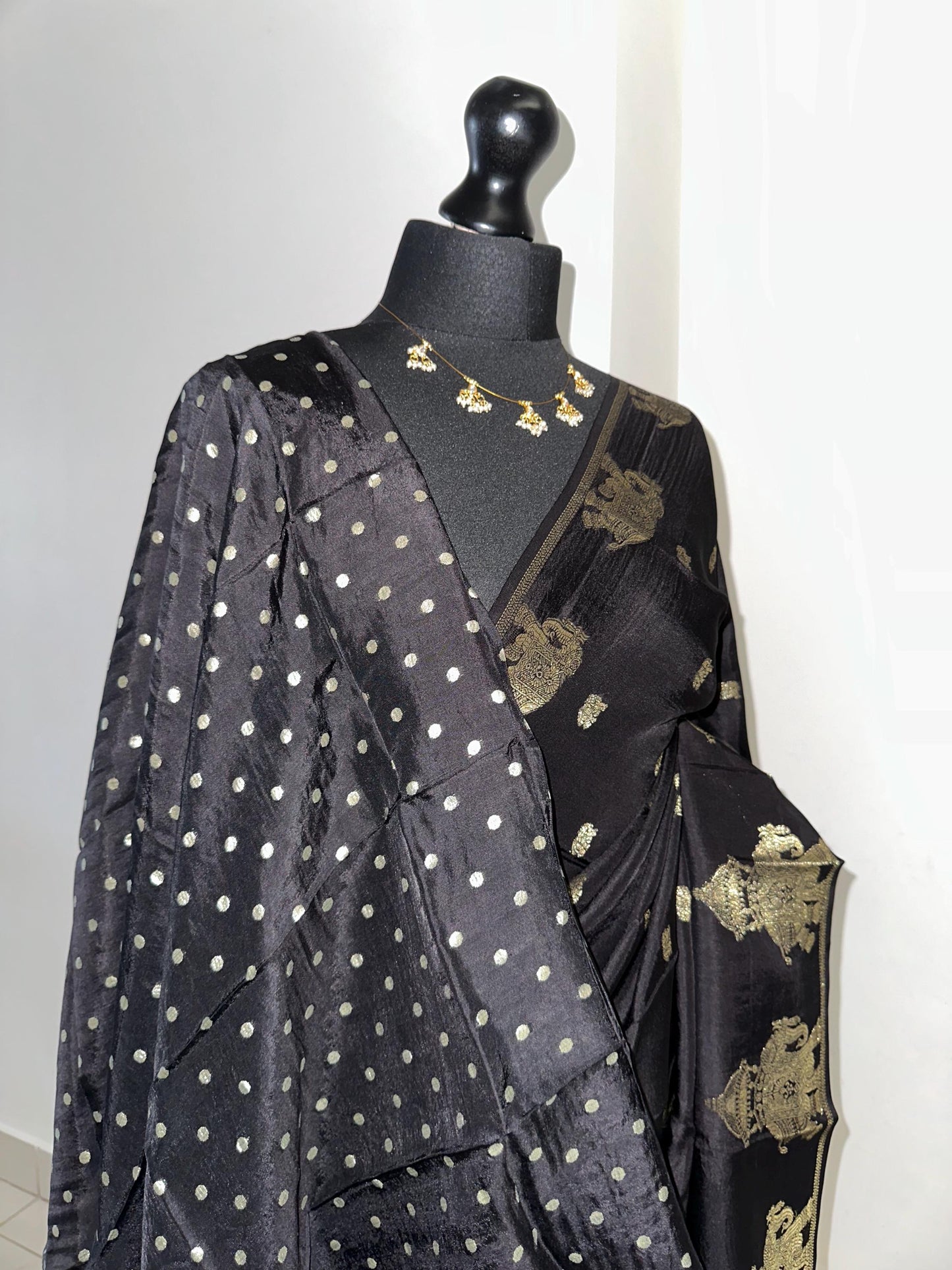 Black semi silk saree with subtle gold zari elephant border and polka dot blouse. Traditional Indian saree elegant festive wear