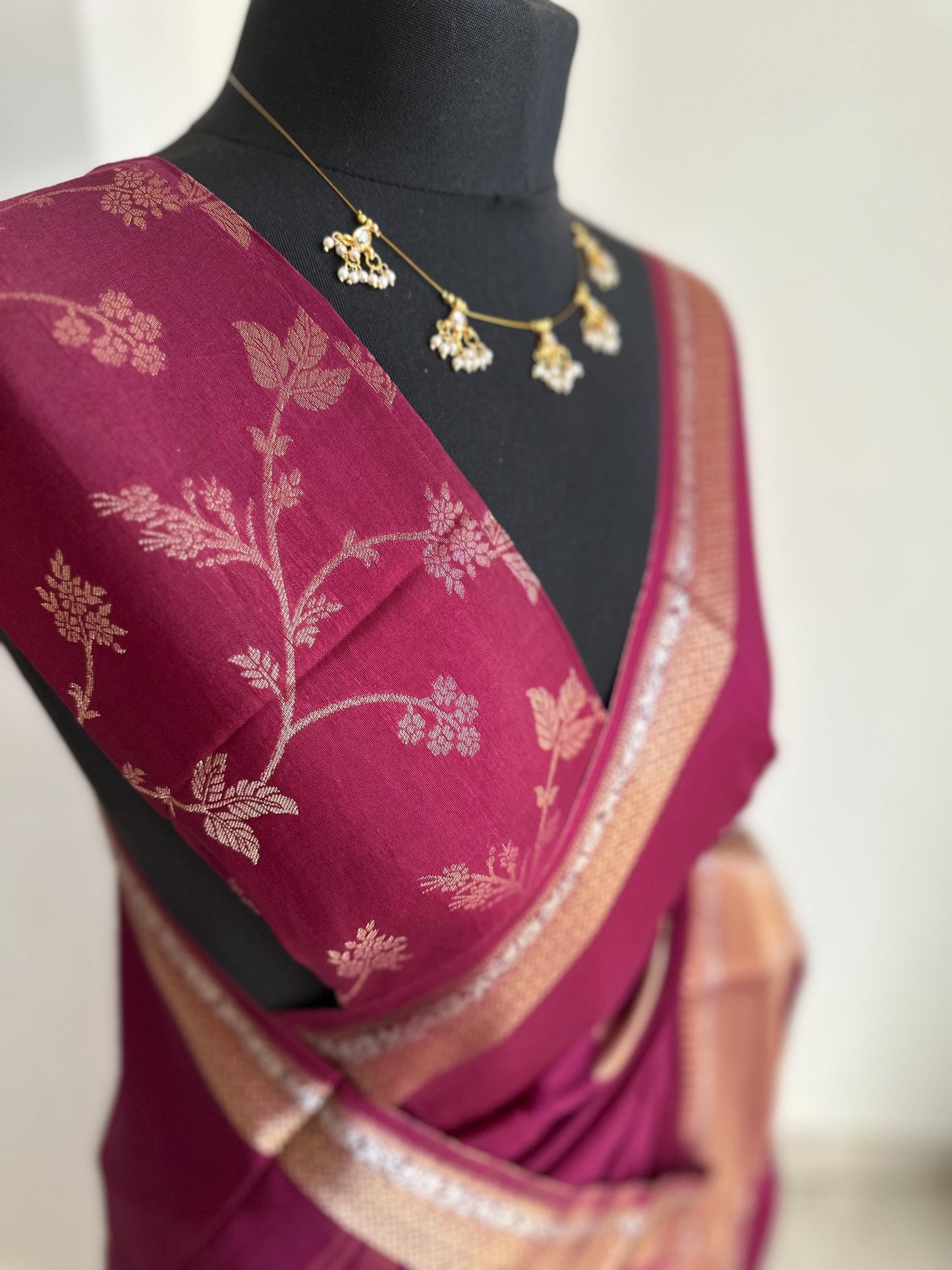 Wine colour semi silk saree with subtle gold and silver zari border and peacock motifs. Floral jaal blouse. Partwear traditional saree