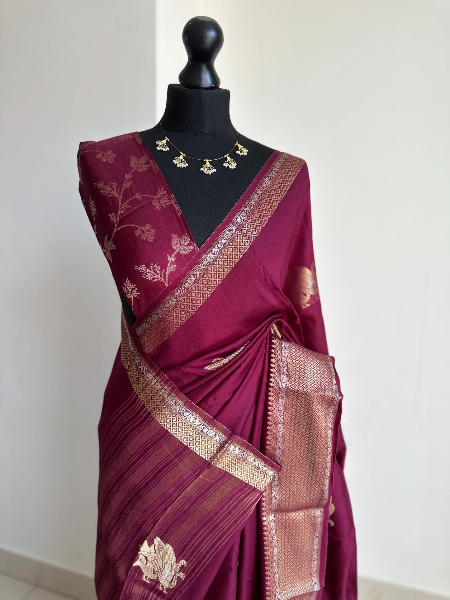Wine colour semi silk saree with subtle gold and silver zari border and peacock motifs. Floral jaal blouse. Partwear traditional saree