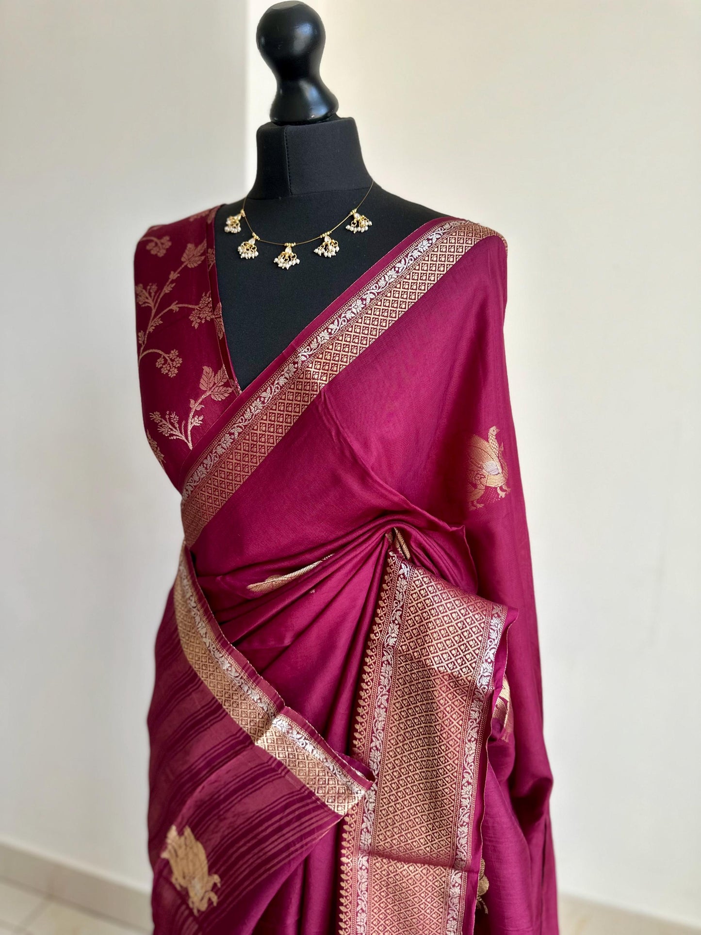 Wine colour semi silk saree with subtle gold and silver zari border and peacock motifs. Floral jaal blouse. Partwear traditional saree