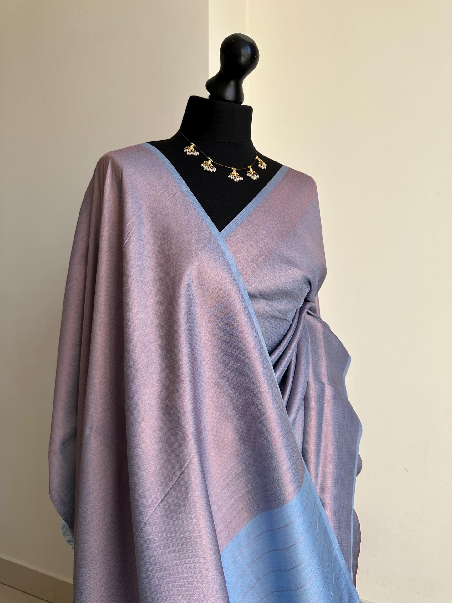 Dusty blue soft silk saree with a copper border and all over sheen. The perfect saree for parties and all traditional events.