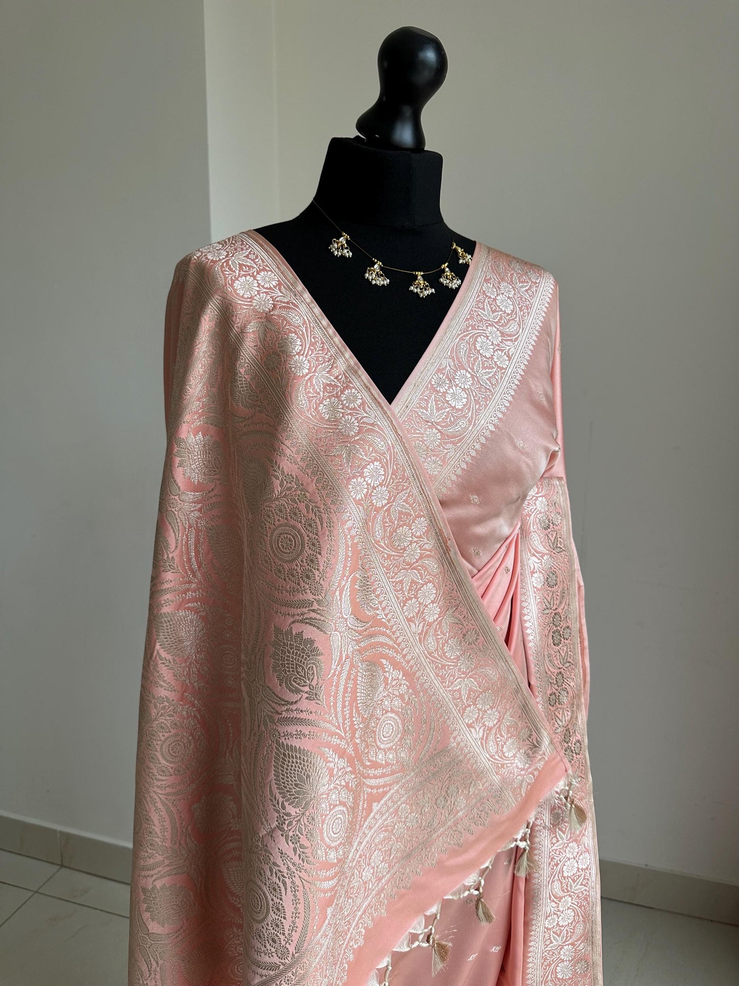 Banarasi silk pastel peach wedding saree with gold Zari. Champagne gold zari on traditional saree with plain contrast unstitched blouse