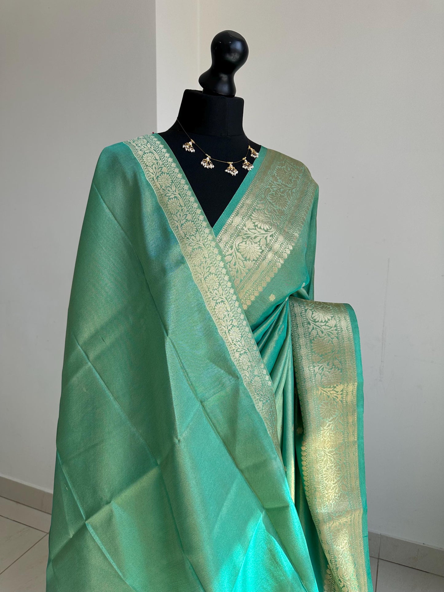 Sea green dual toned shimmer soft tissue saree with border and unstitched blouse. Statement tissue saree for wedding events