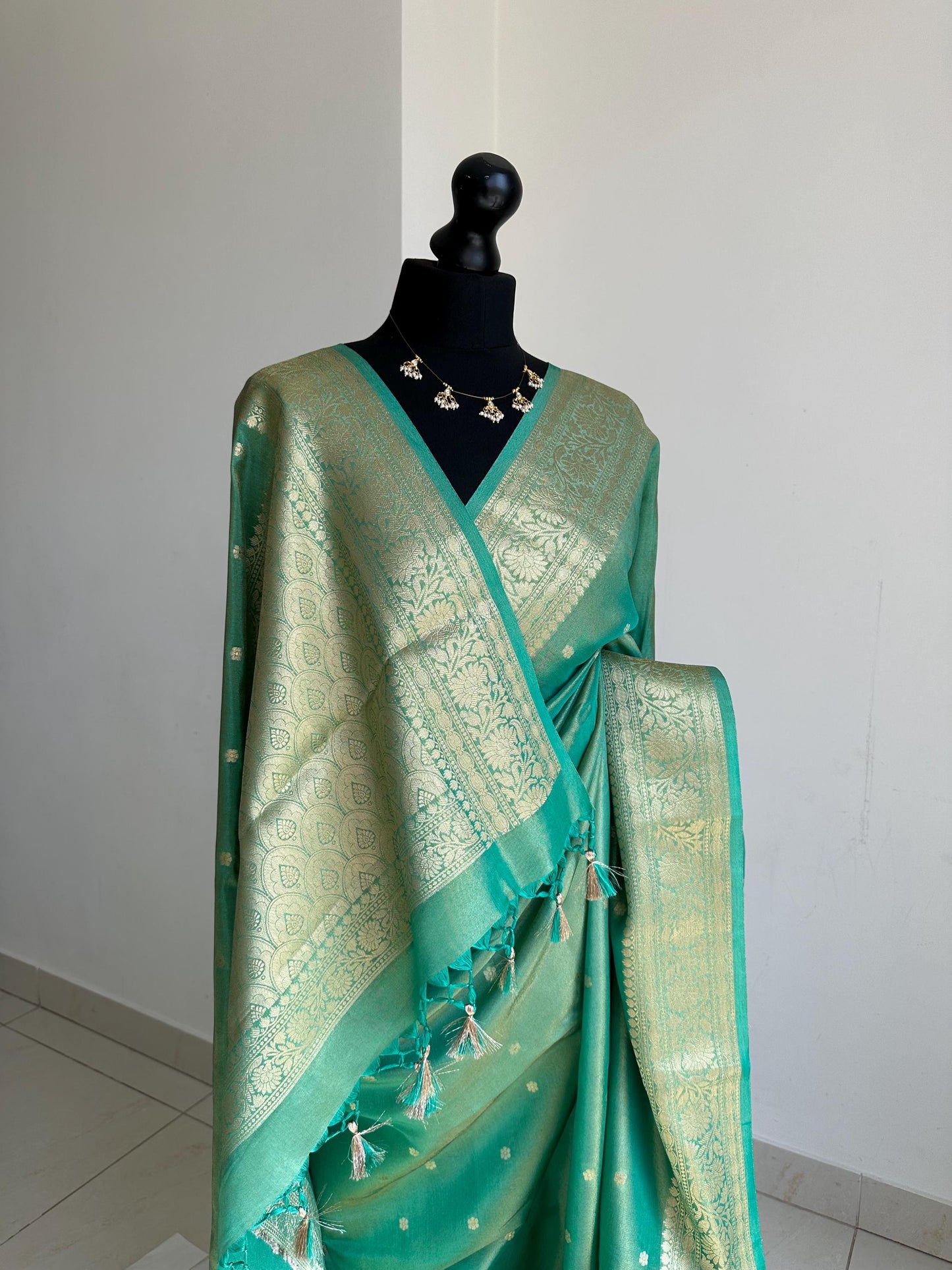 Sea green dual toned shimmer soft tissue saree with border and unstitched blouse. Statement tissue saree for wedding events