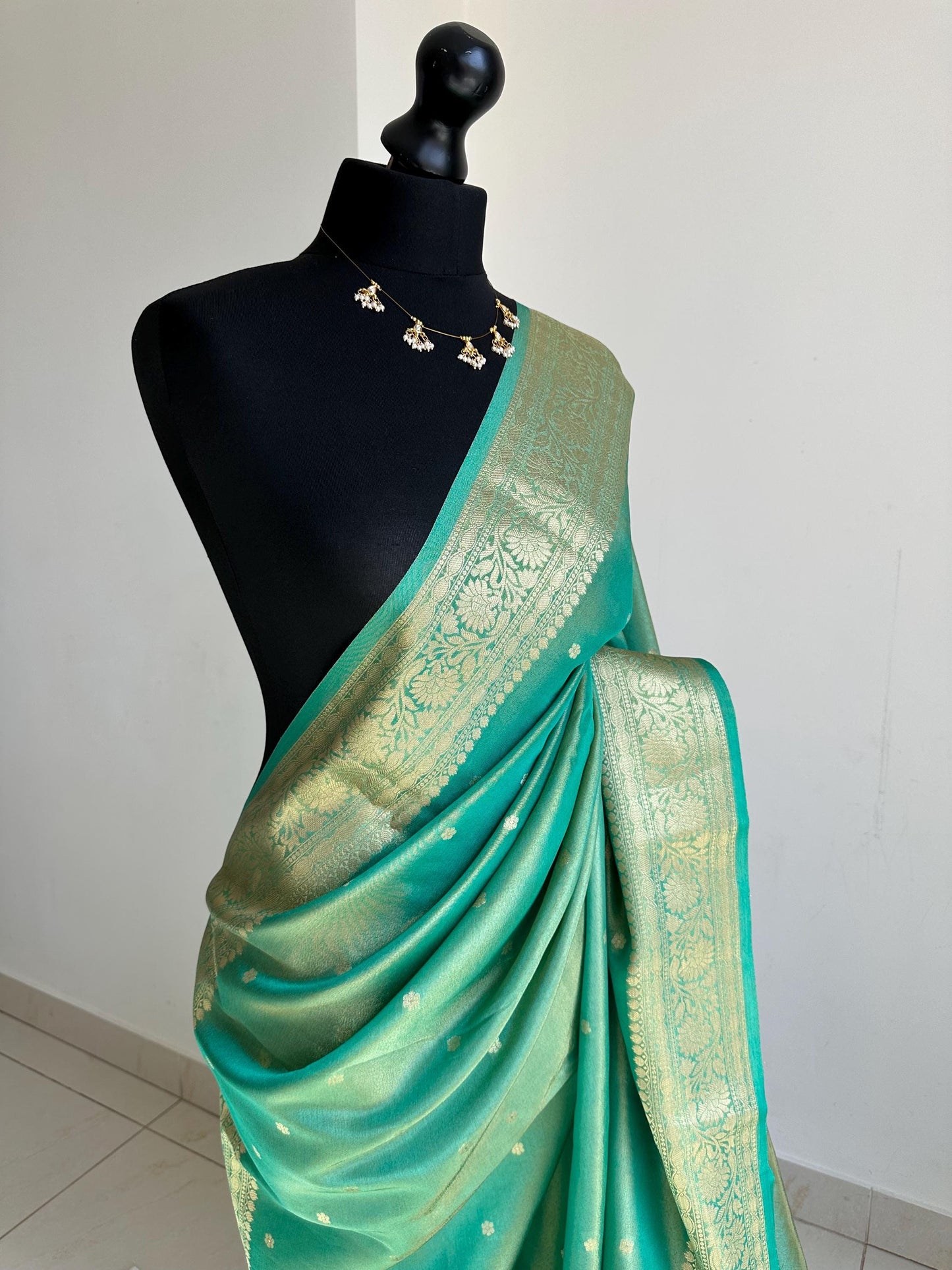 Sea green dual toned shimmer soft tissue saree with border and unstitched blouse. Statement tissue saree for wedding events