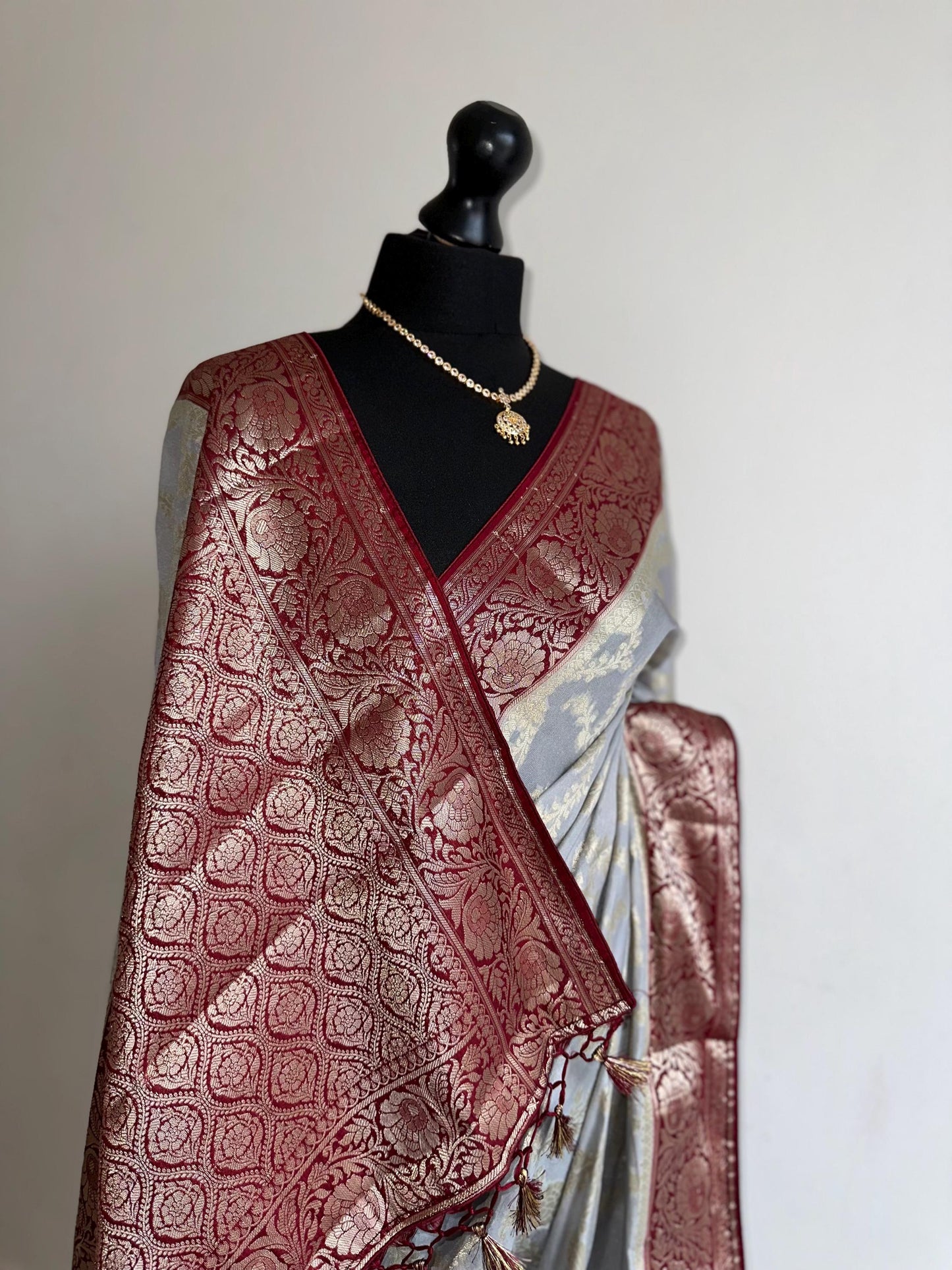 Grey and maroon Banarasi Georgette Silk Saree with all over jaal design. Statement yet elegant saree thats soft to drape and pleat.