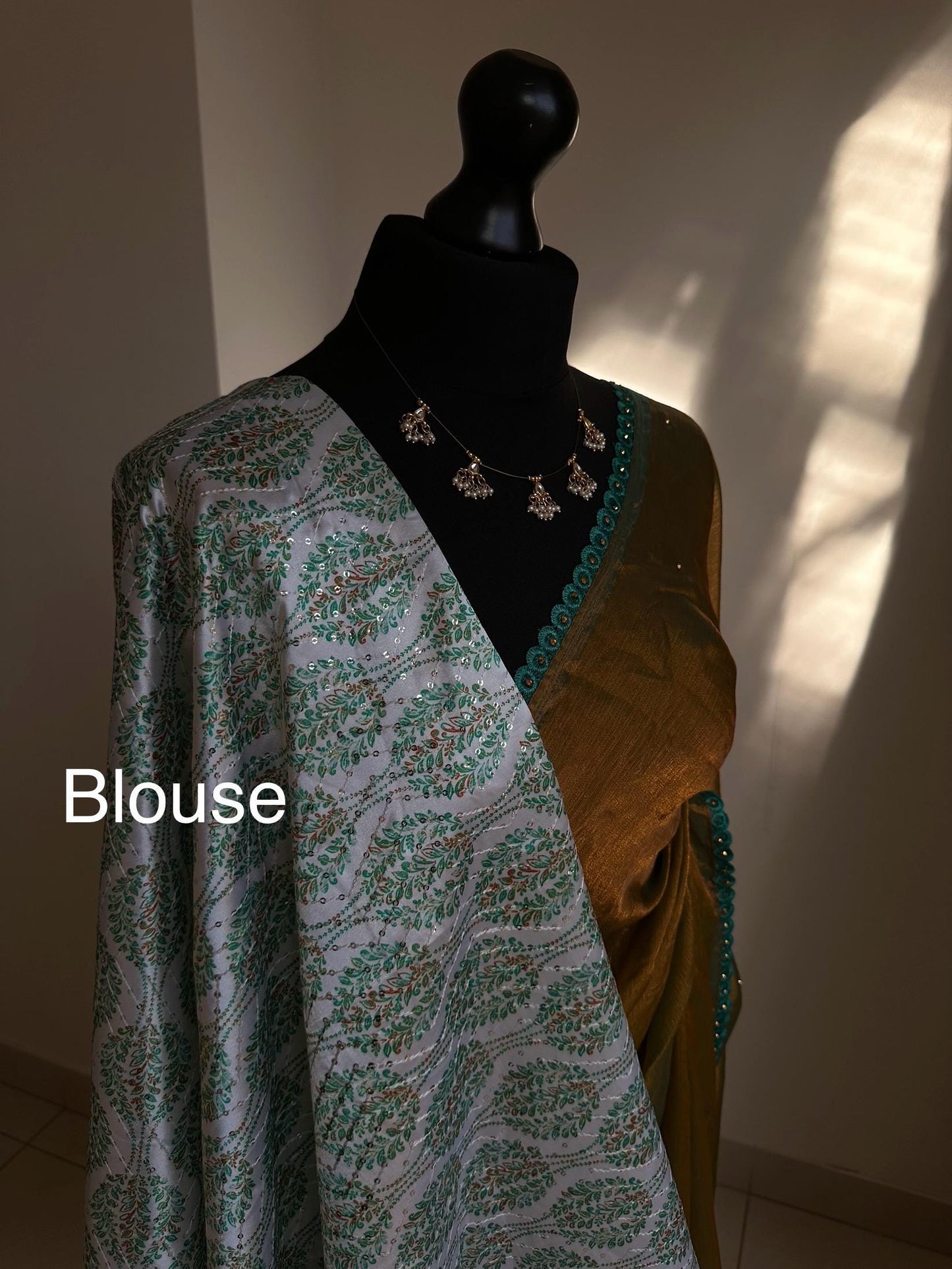 Dual toned olive green party saree with green trim border and contrast printed blouse. Unique statement saree can styled with other blouses
