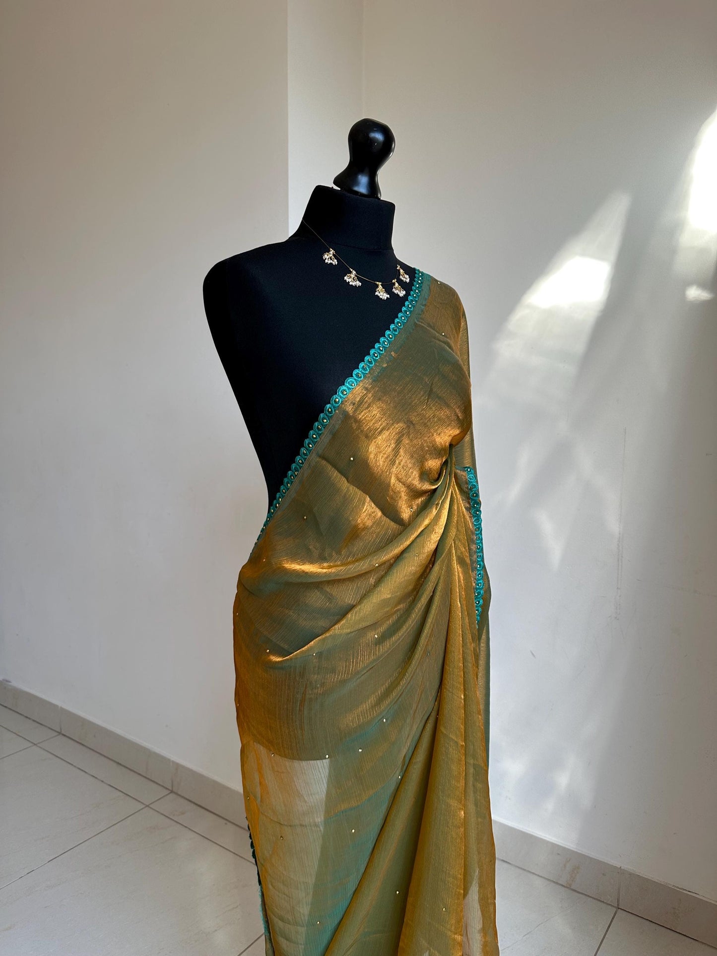 Dual toned olive green party saree with green trim border and contrast printed blouse. Unique statement saree can styled with other blouses