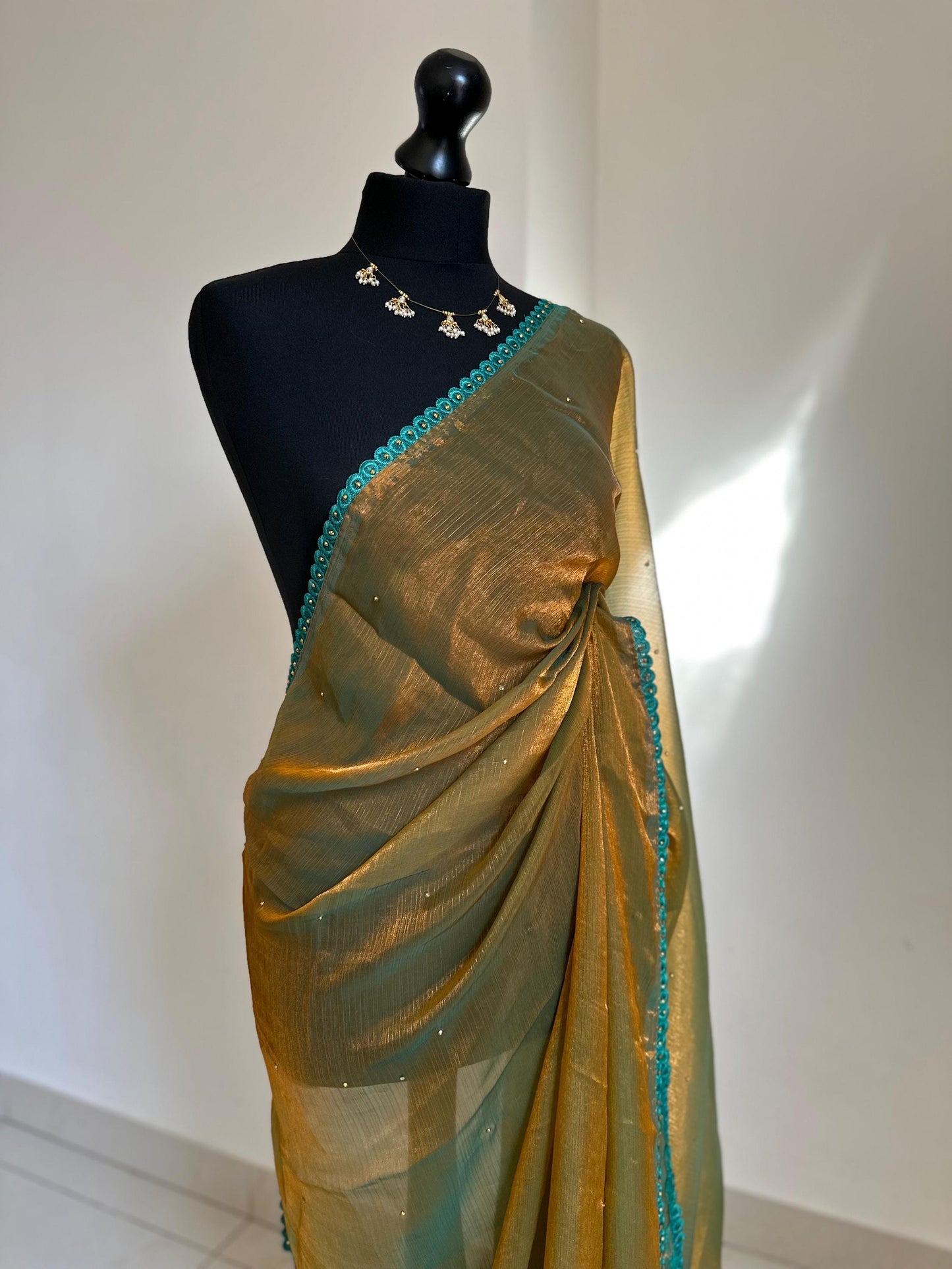 Dual toned olive green party saree with green trim border and contrast printed blouse. Unique statement saree can styled with other blouses