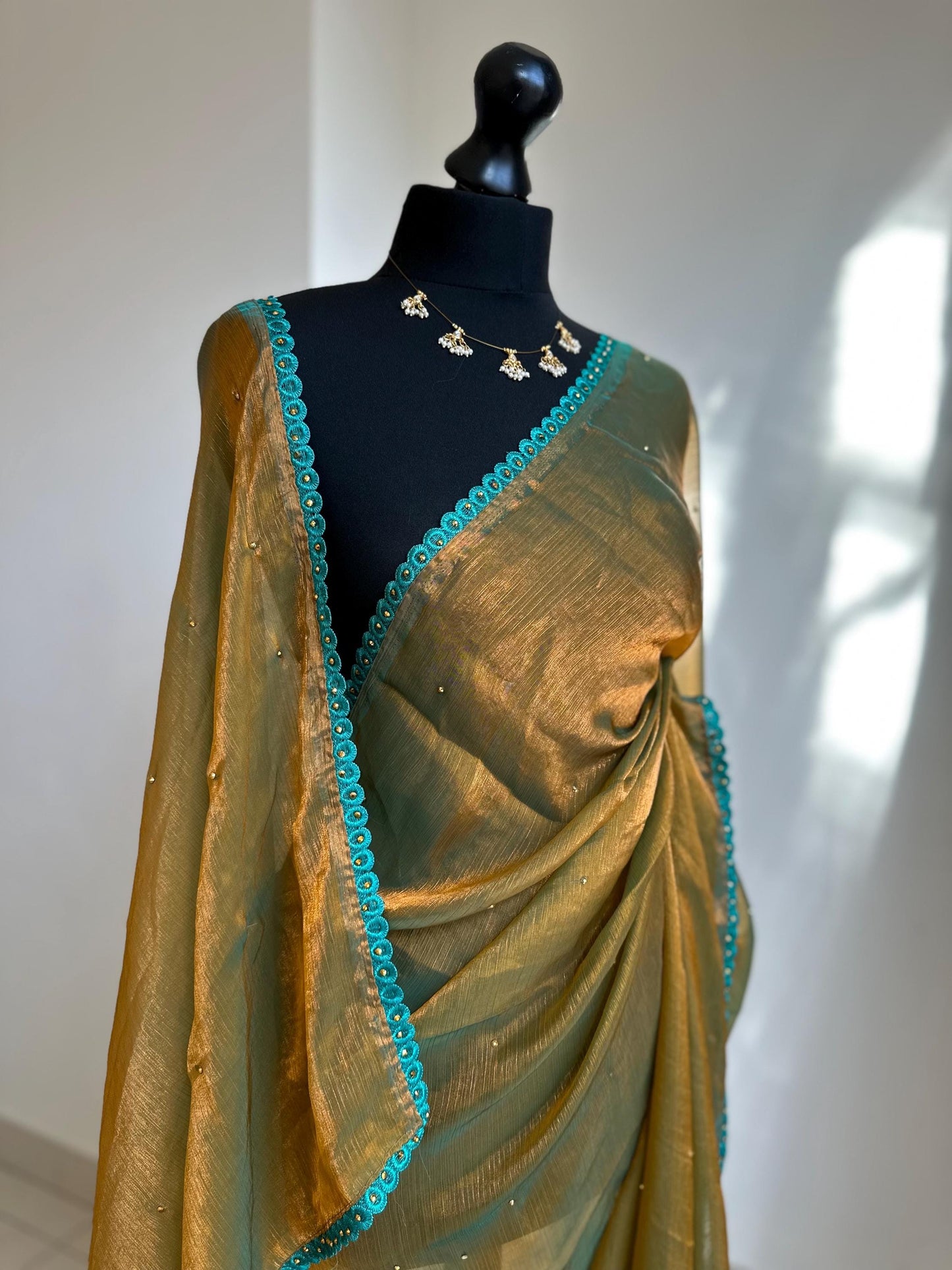 Dual toned olive green party saree with green trim border and contrast printed blouse. Unique statement saree can styled with other blouses
