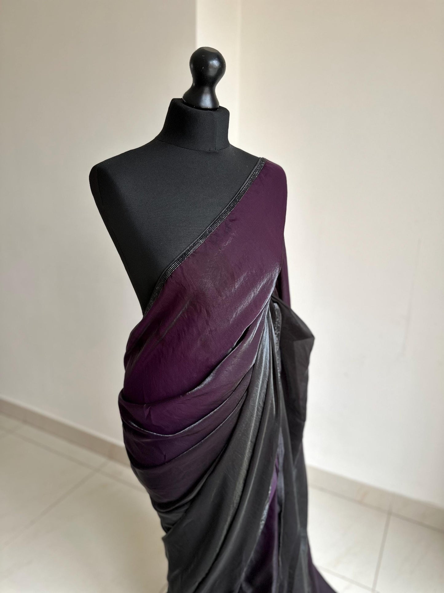 Ready-pleated black and purple shaded saree with cutdana stonework border, comes with belt. Prestitched saree for parties