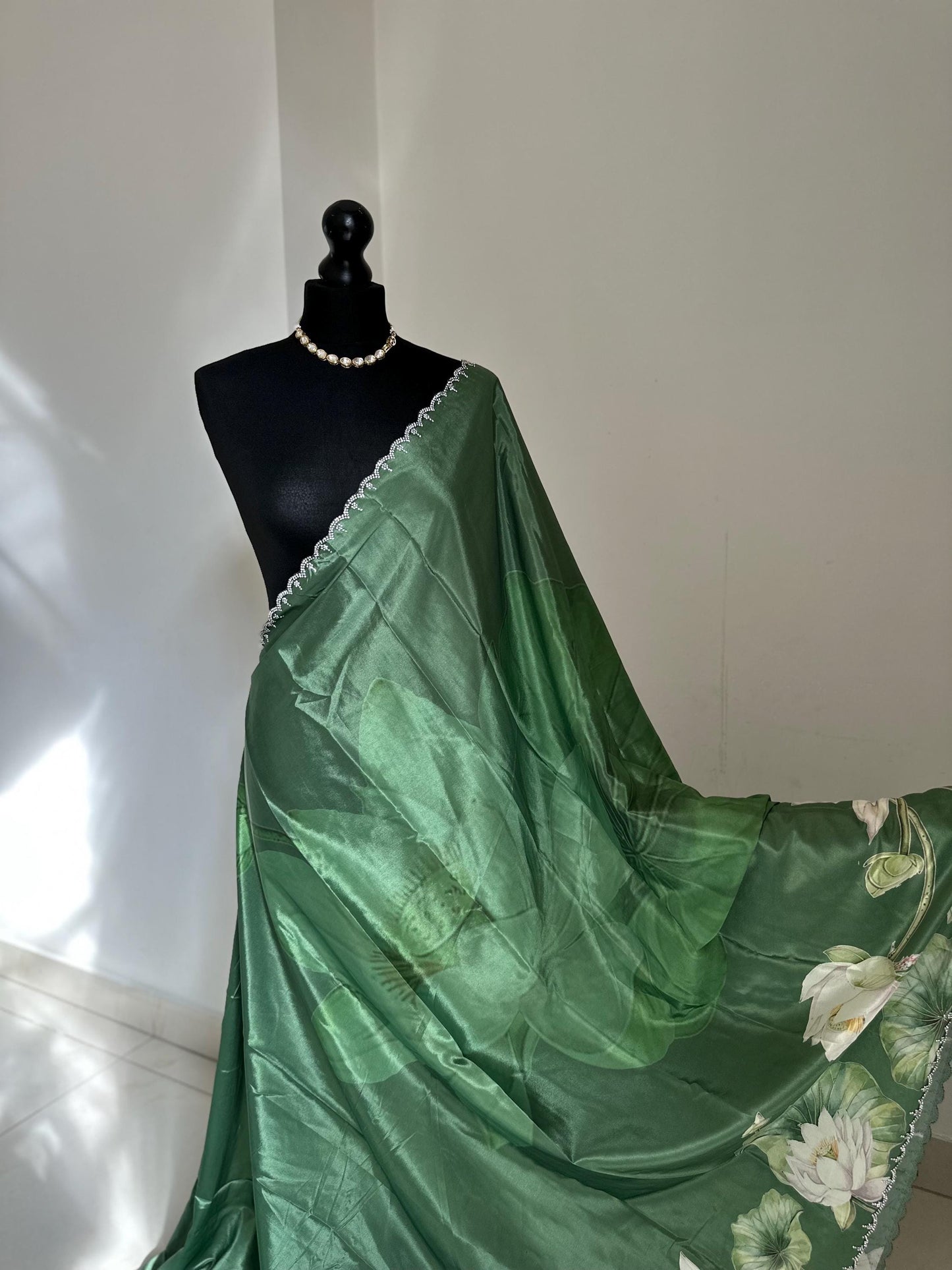 Green floral party saree with embellished scalloped border. Soft satin versatile saree thats perfect for parties and evening events.