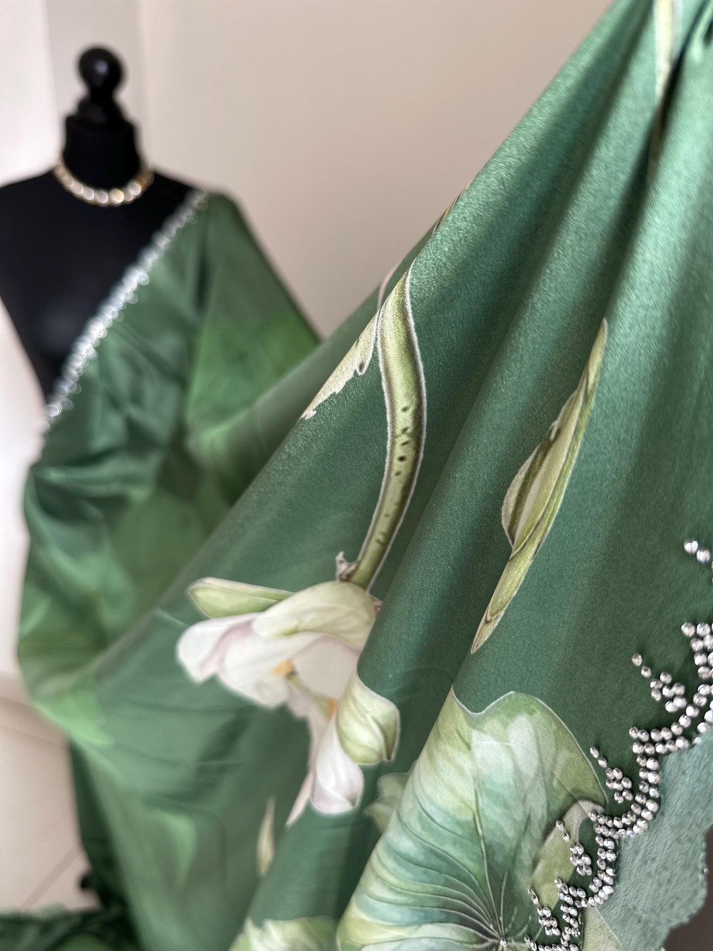 Green floral party saree with embellished scalloped border. Soft satin versatile saree thats perfect for parties and evening events.