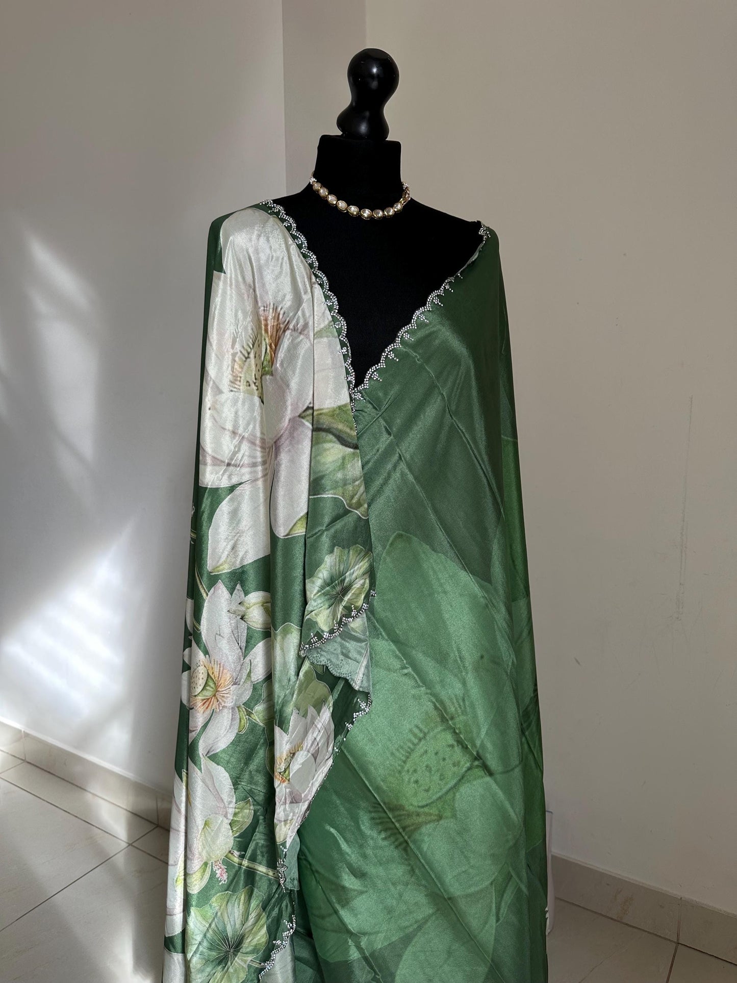 Green floral party saree with embellished scalloped border. Soft satin versatile saree thats perfect for parties and evening events.
