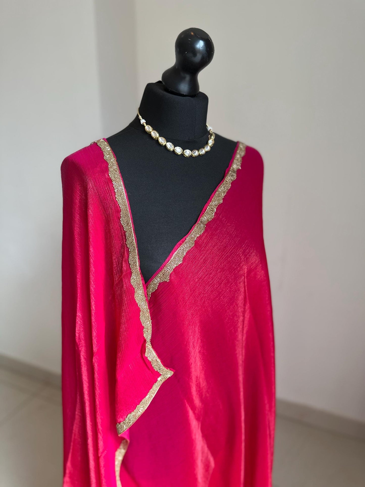 Deep pink chiffon saree with cutdana border. Crafted from soft shimmer chiffon this saree is perfect for parties and evening occasions