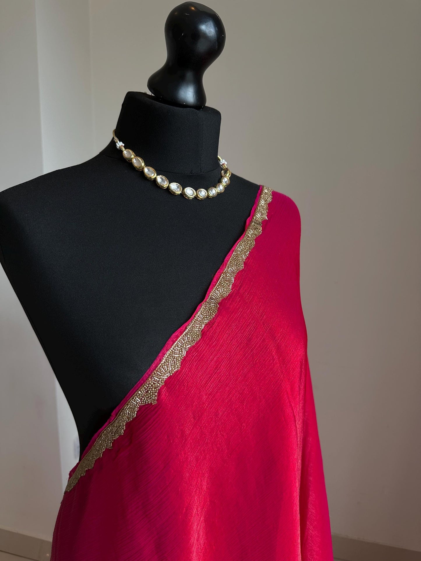 Deep pink chiffon saree with cutdana border. Crafted from soft shimmer chiffon this saree is perfect for parties and evening occasions
