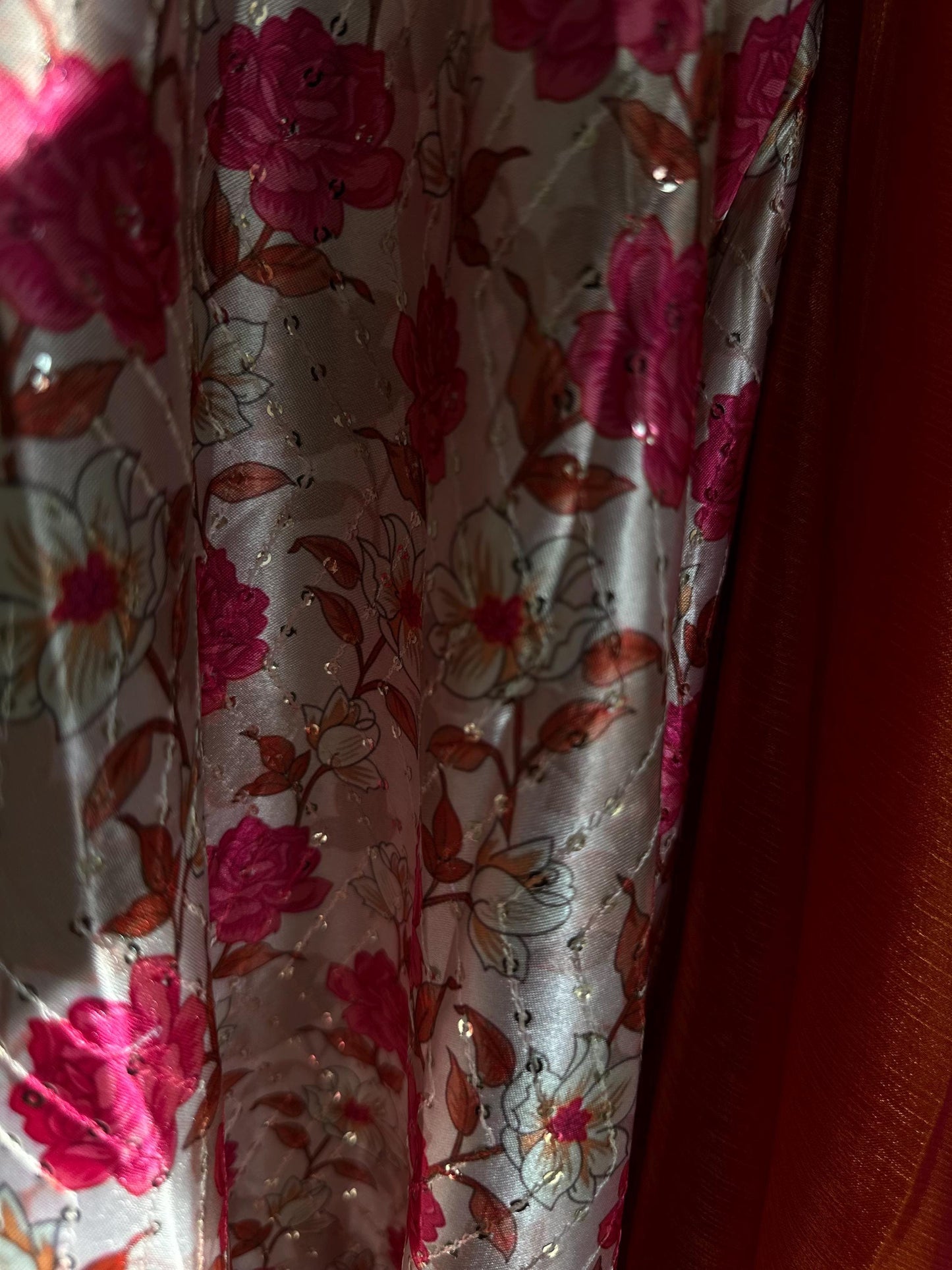 Dual toned coral party designer saree with pink trim border and contrast floral blouse. Unique statement saree can styled with other blouses