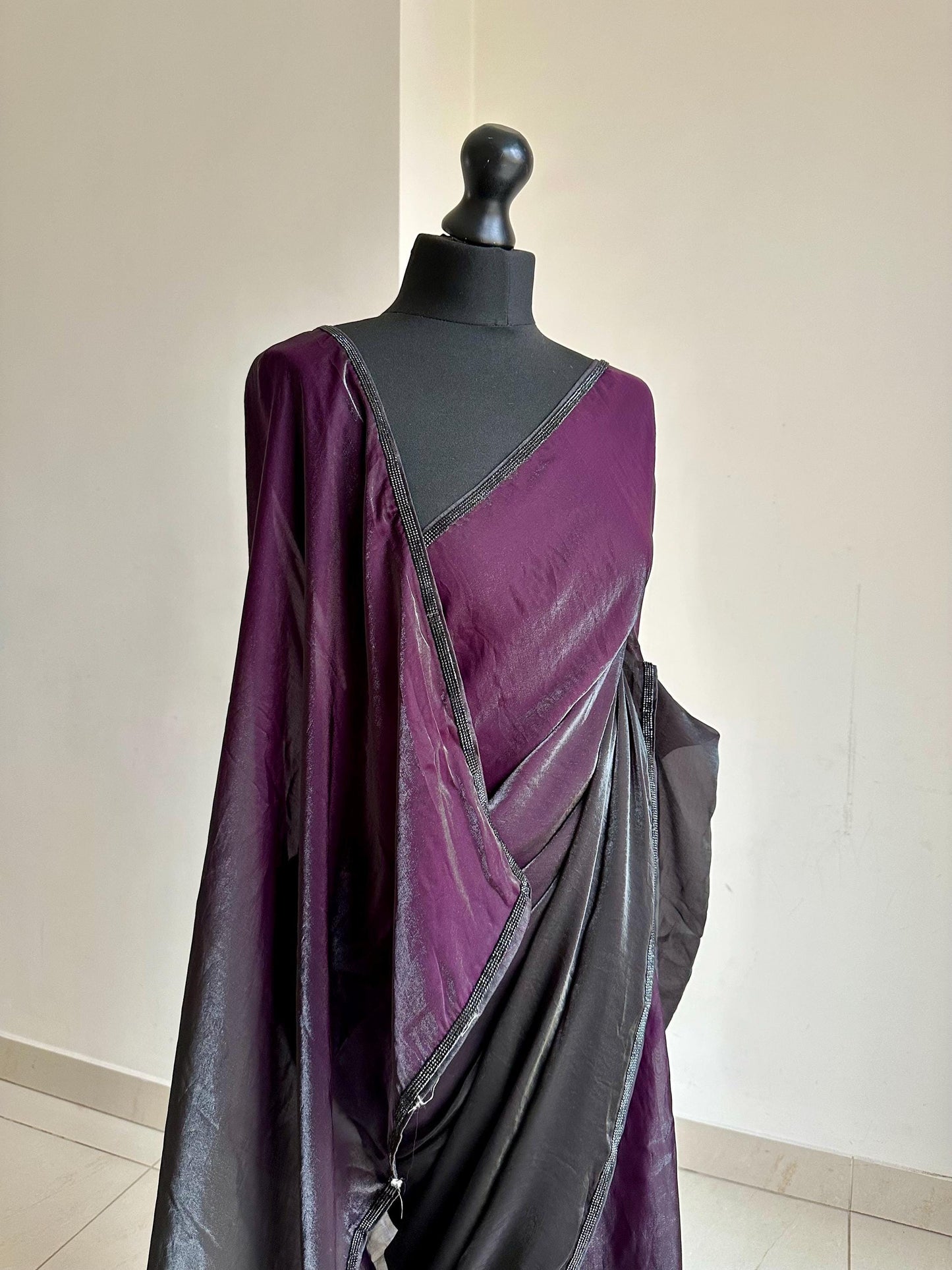 Ready-pleated black and purple shaded saree with cutdana stonework border, comes with belt. Prestitched saree for parties