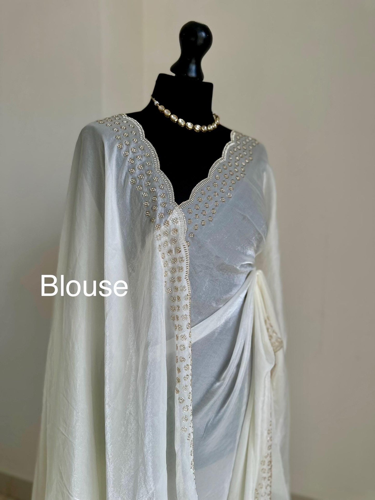 Off white party bridal saree with embellished scalloped border. Soft chiffon versatile saree thats perfect for parties and evening events.