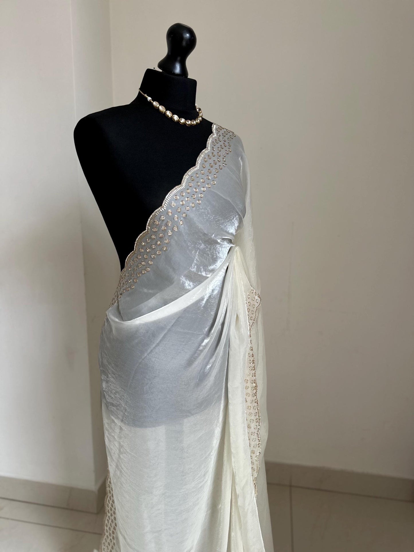 Off white party bridal saree with embellished scalloped border. Soft chiffon versatile saree thats perfect for parties and evening events.