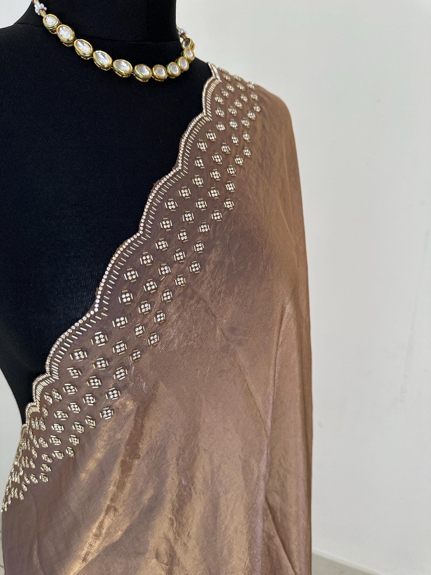Copper brown party saree with embellished scalloped border. Soft chiffon versatile saree thats perfect for parties and evening events.