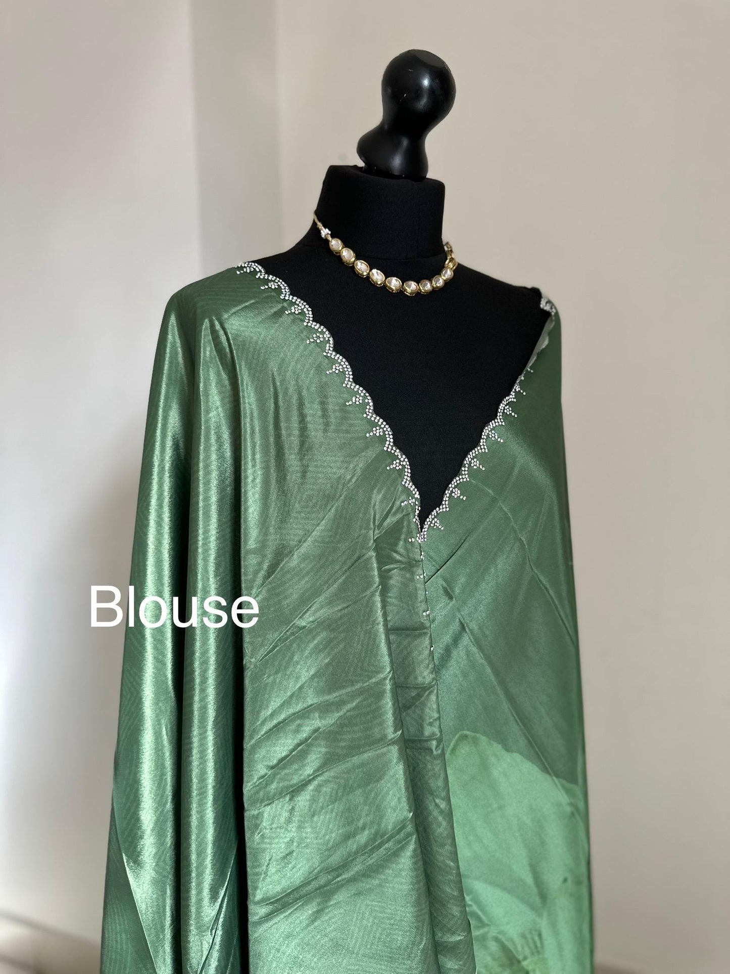 Green floral party saree with embellished scalloped border. Soft satin versatile saree thats perfect for parties and evening events.