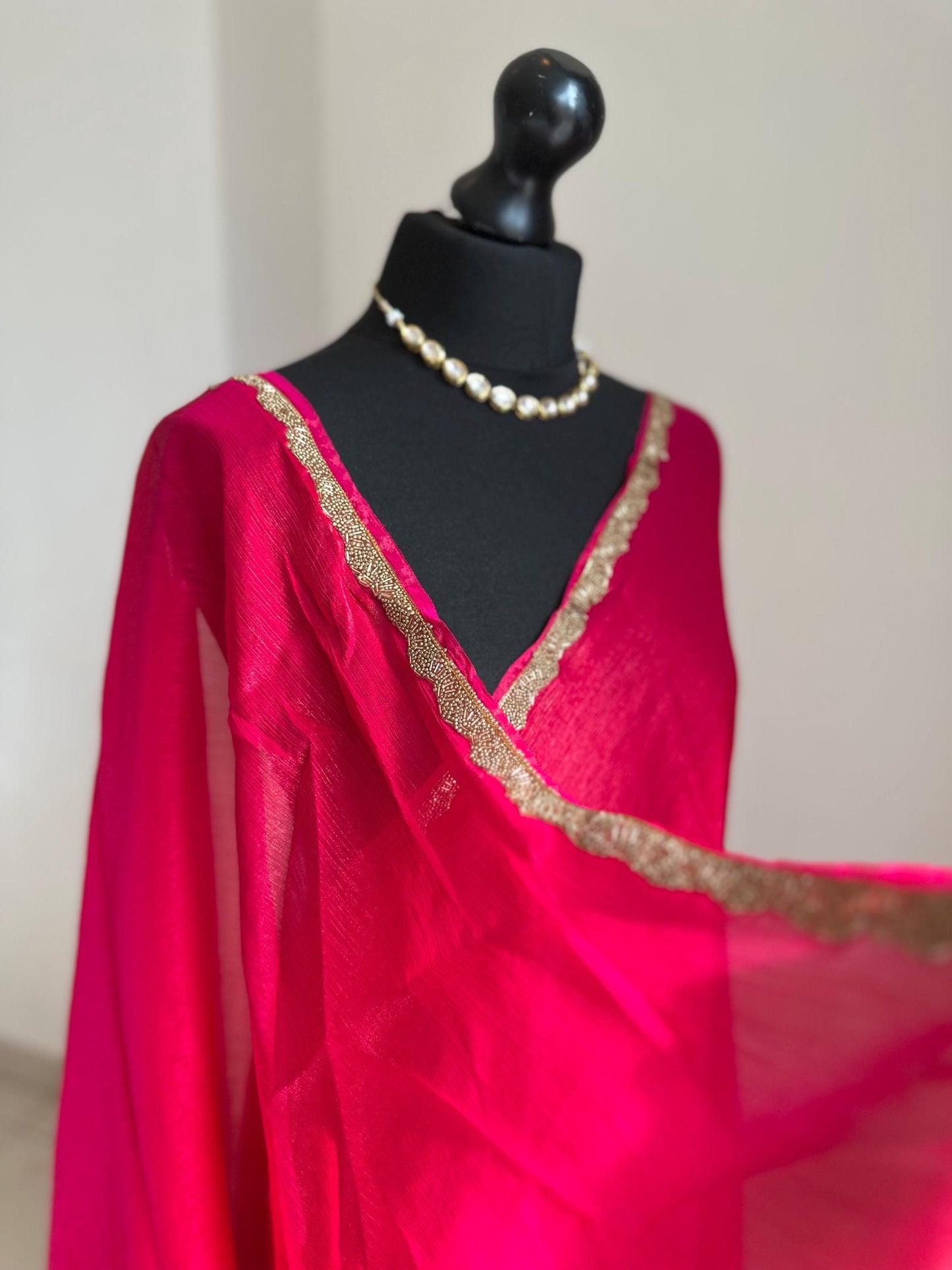 Deep pink chiffon saree with cutdana border. Crafted from soft shimmer chiffon this saree is perfect for parties and evening occasions