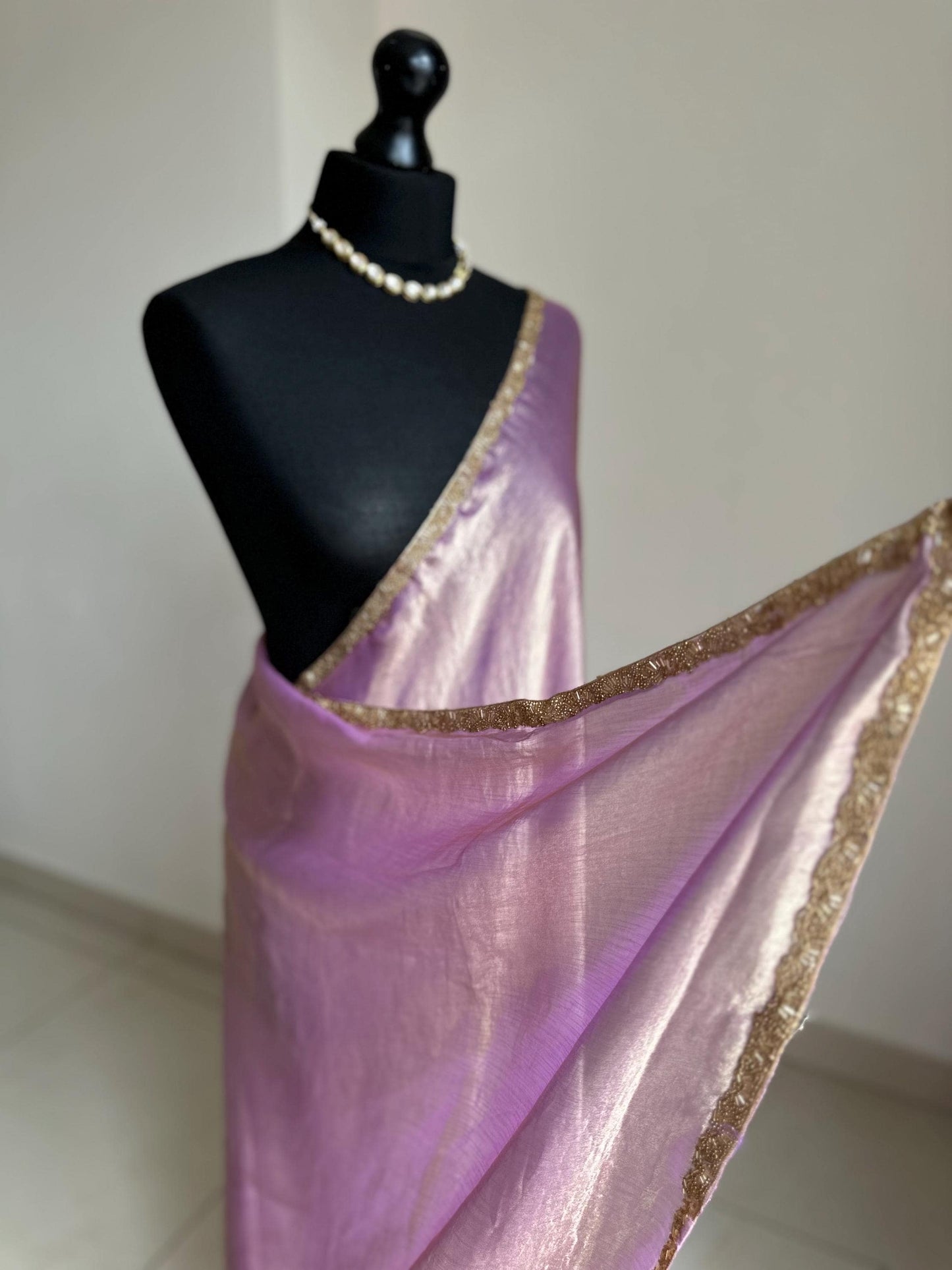 Lilac chiffon saree with cutdana border. Crafted from soft shimmer chiffon this saree is perfect for parties and evening occasions