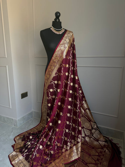 Wine satin finish Banarasi silk saree with intricate gold zari border and design